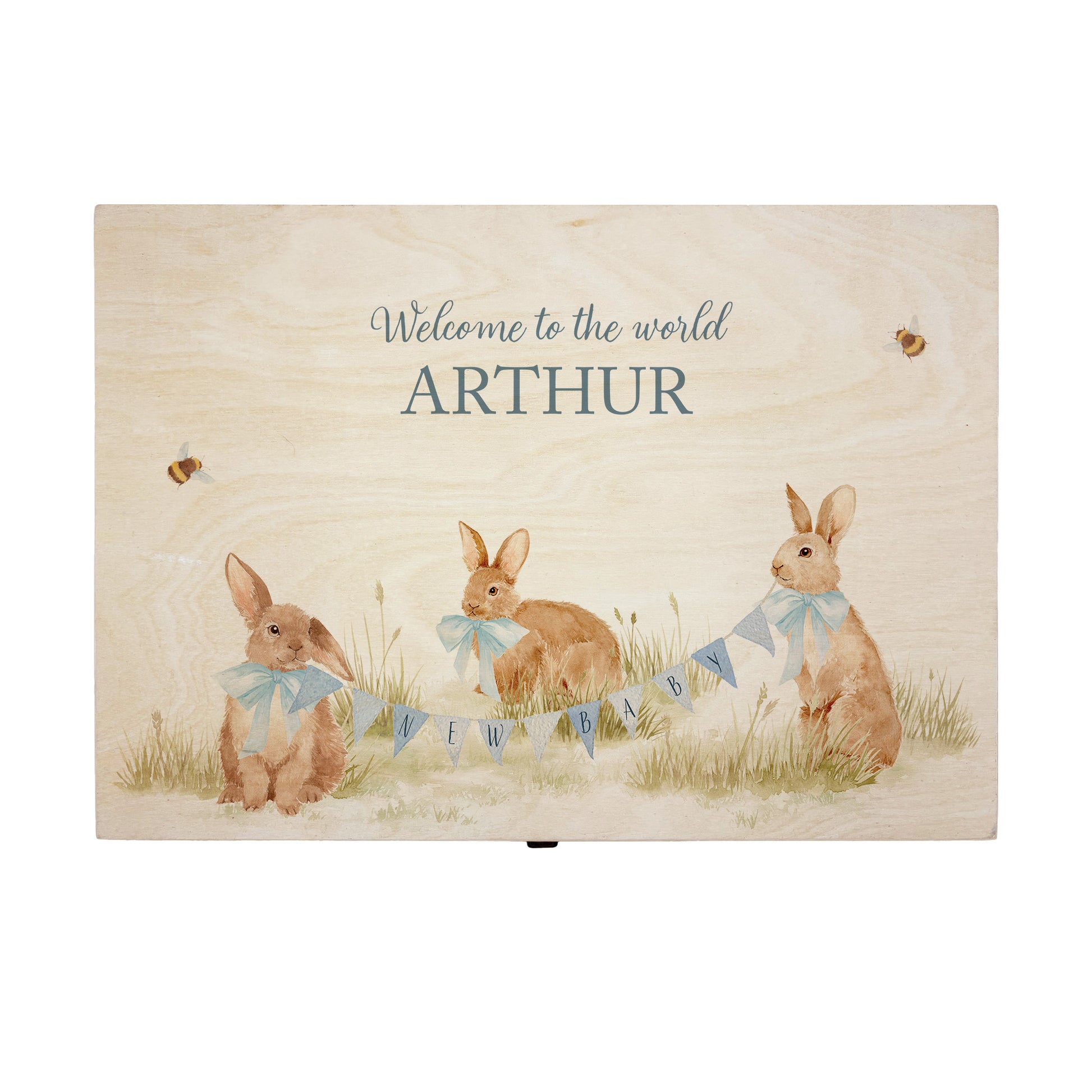 Large sized wooden pine personalised keepsake box. The design theme is perfect for New babies, Welcome to the world, baby showers and christenings. This design has baby bunnies, playing in a meadow style grass and a buzzy Bee flying around. This design can be personalised by adding a beautiful bunting and a luxurious bow around their necks in blue or pink. Add the extra special touch to your special occasion.