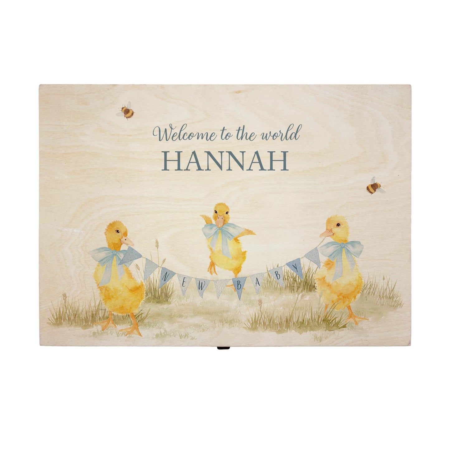 Large sized wooden pine personalised keepsake box. The design theme is perfect for New babies, Welcome to the world, baby showers and christenings. This design has baby ducklings in meadow style grass and a buzzy Bee flying around. This design can be personalised by adding a beautiful bunting and a luxurious bow around their necks in blue or pink. Add the extra special touch to your special occasion.