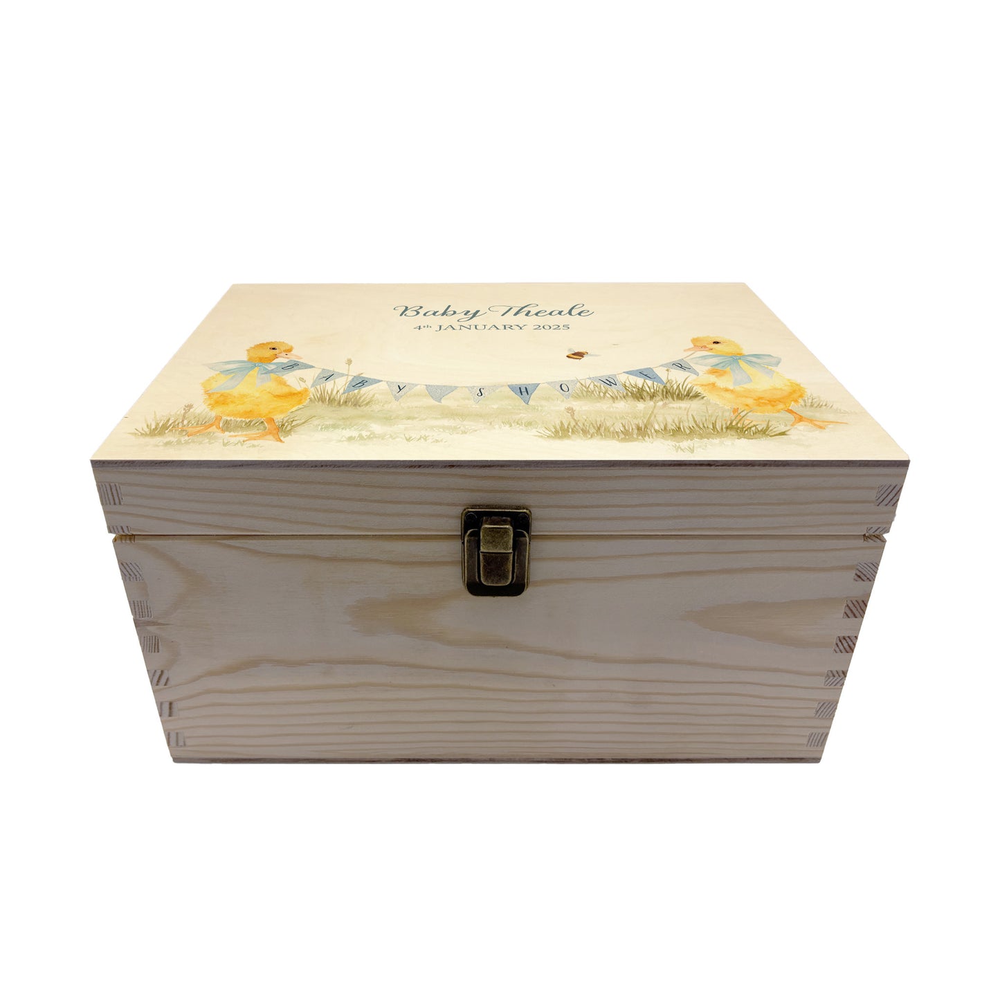 Medium sized wooden pine personalised keepsake box. The design theme is perfect for New babies, Welcome to the world, baby showers and christenings. This design has baby ducklings  in meadow style grass and a buzzy Bee flying around. This design can be personalised by adding a beautiful bunting and a luxurious bow around their necks in blue or pink. Add the extra special touch to your special occasion.