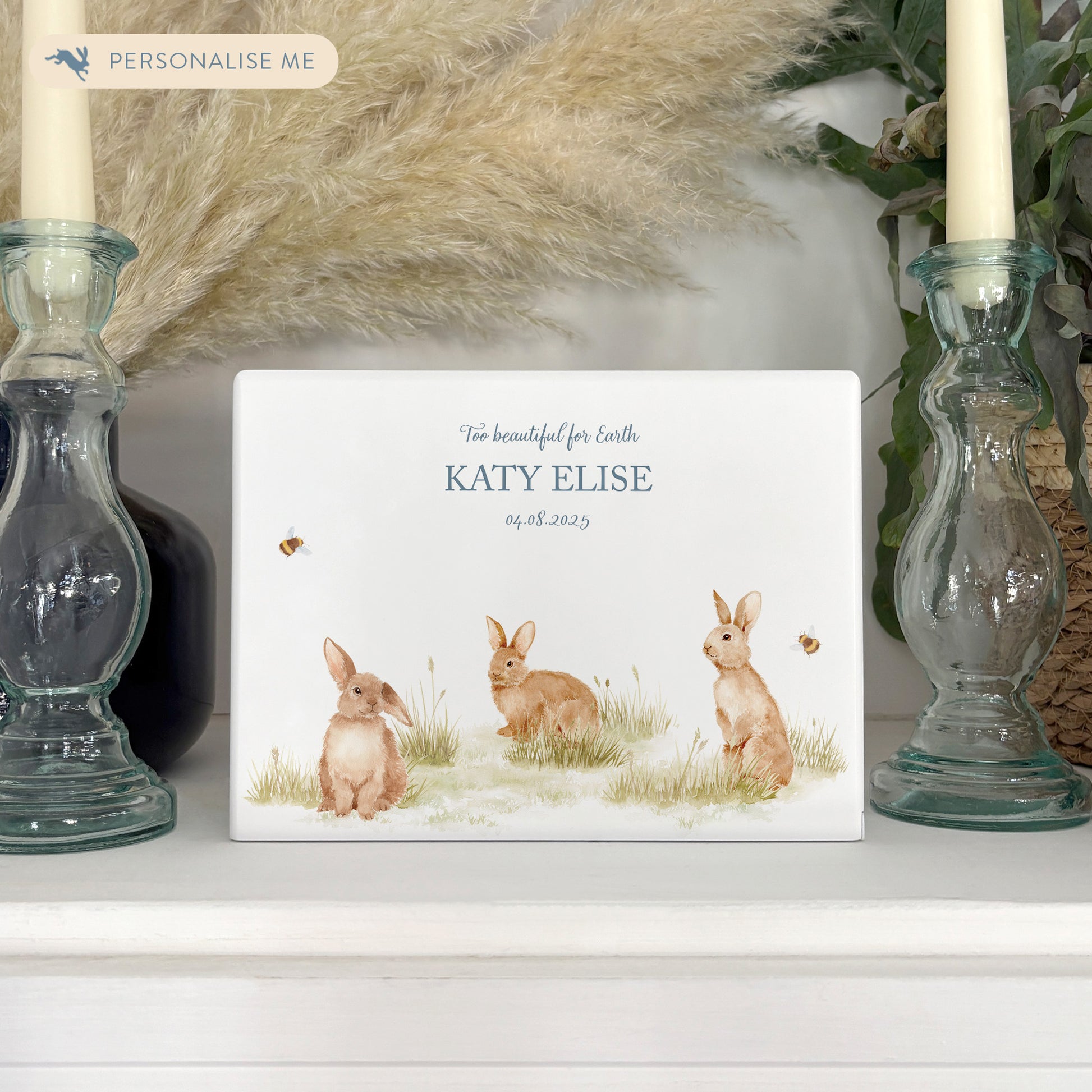 Luxury solid wooden white painted Urn  with Baby Bunnies in a meadow with Buzzy Bees in a beautiful watercolour illustration our urns and Caskets for displaying or burying ashes. Customisable and can be personalised. Perfect funeral memory keepsake urn, for storing ashes for humans and pets. Coping with baby loss.