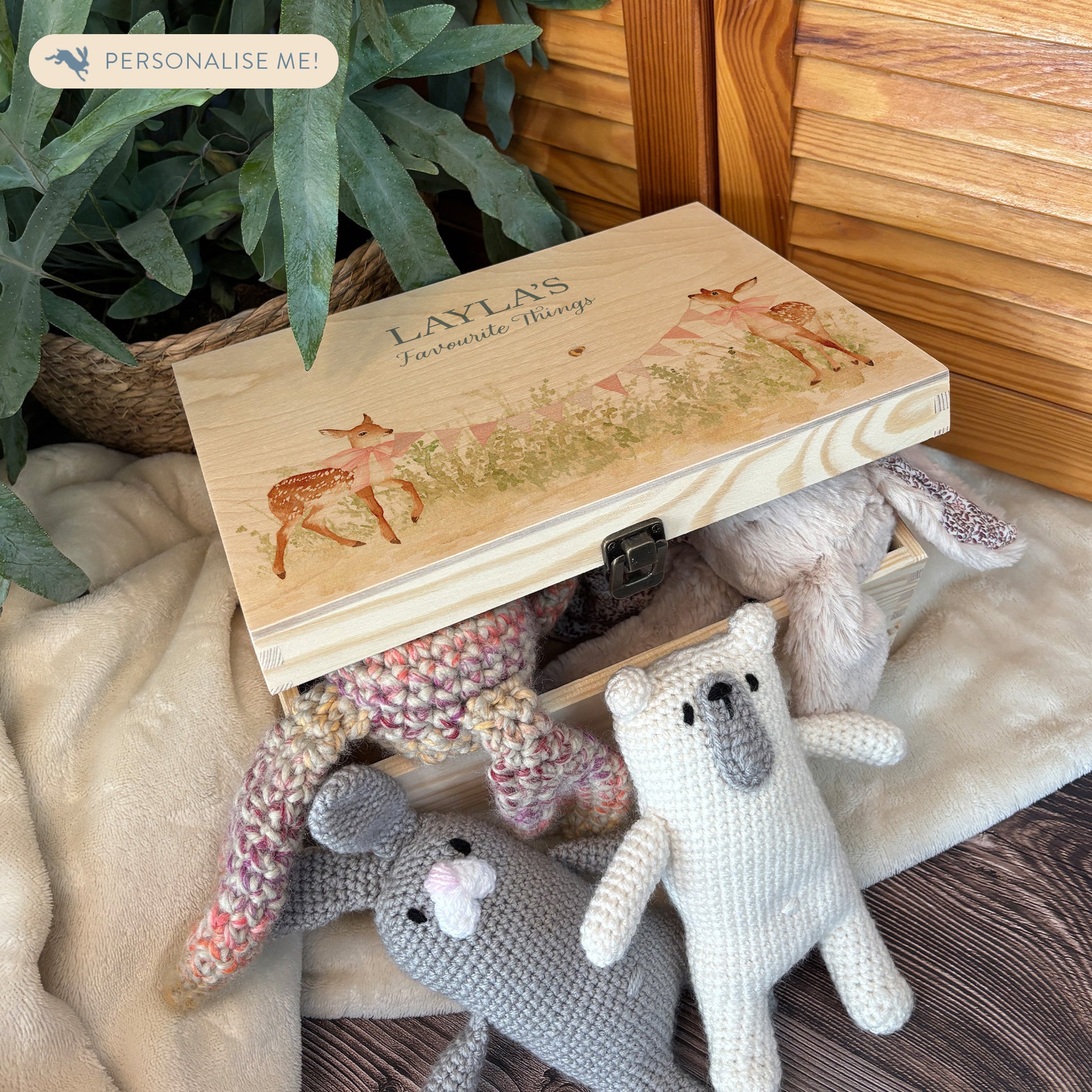 Medium sized wooden pine personalised keepsake box. The design theme is perfect for New babies, Welcome to the world, baby showers and christenings. This design has baby Fawns/Deer  in meadow style grass and a buzzy Bee flying around. This design can be personalised by adding a beautiful bunting and a luxurious bow around their necks in blue or pink. Add the extra special touch to your special occasion.  The picture also shows an example in a nursey room filled with nappies, vests and teddys.