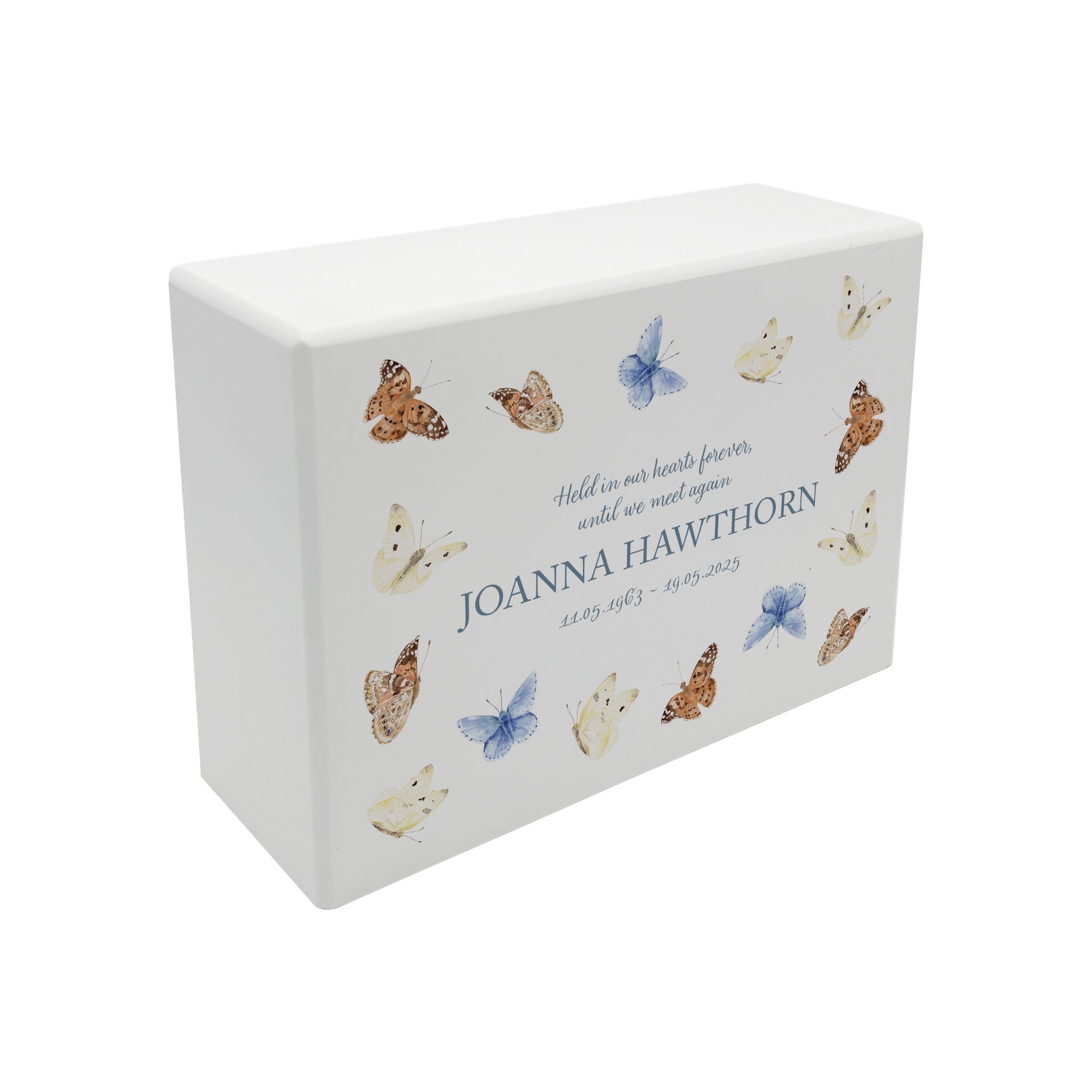 A beautifully crafted solid wooden urn, finished in white with a soft watercolour design of flying Butterflies, Thoughtfully made for either display or burial, this personalised urn can be customised to create a meaningful memorial. Perfect for holding ashes of a loved one or a beloved pet, it serves as a comforting tribute and keepsake.