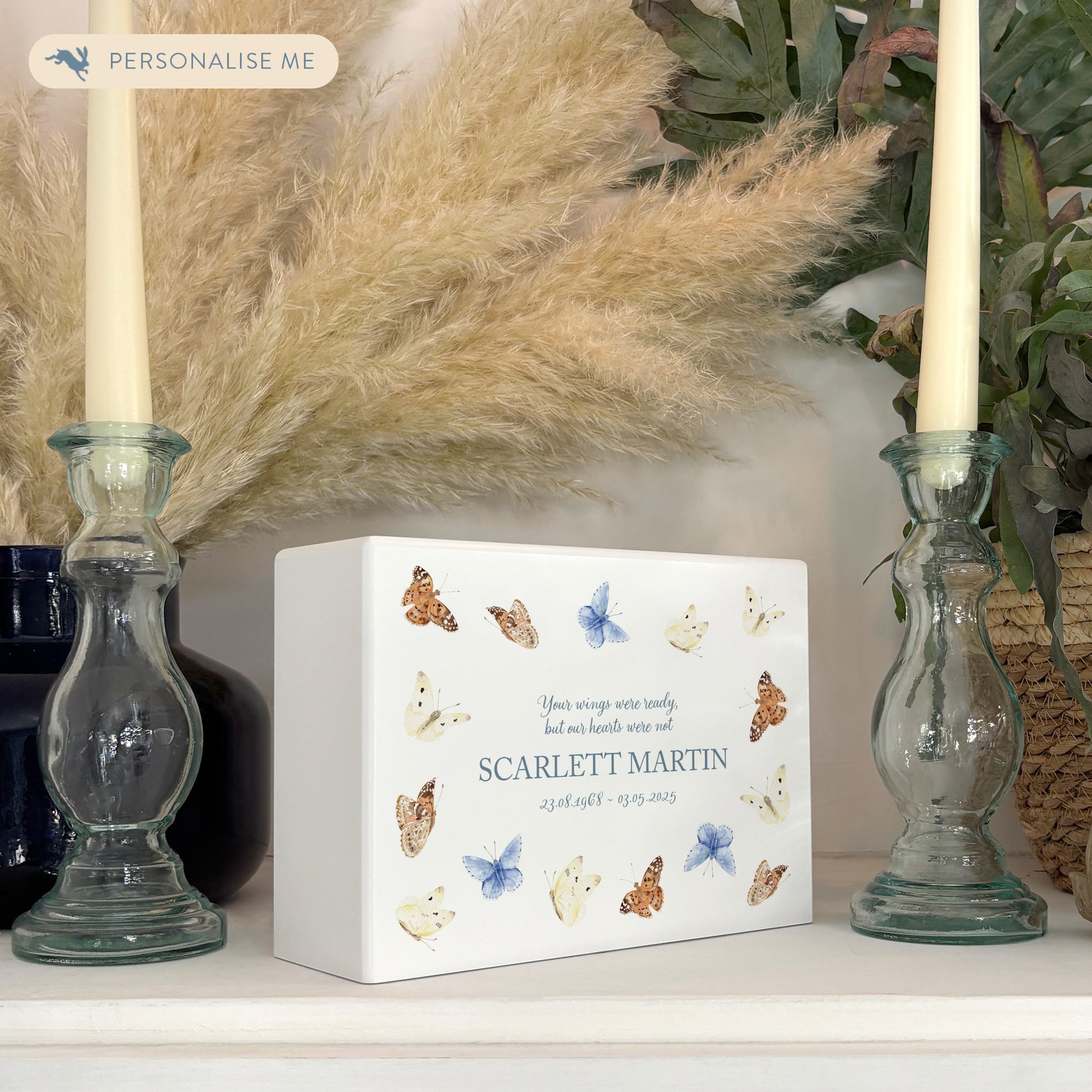 A beautifully crafted solid wooden urn, finished in white with a soft watercolour design of flying Butterflies, Thoughtfully made for either display or burial, this personalised urn can be customised to create a meaningful memorial. Perfect for holding ashes of a loved one or a beloved pet, it serves as a comforting tribute and keepsake.
