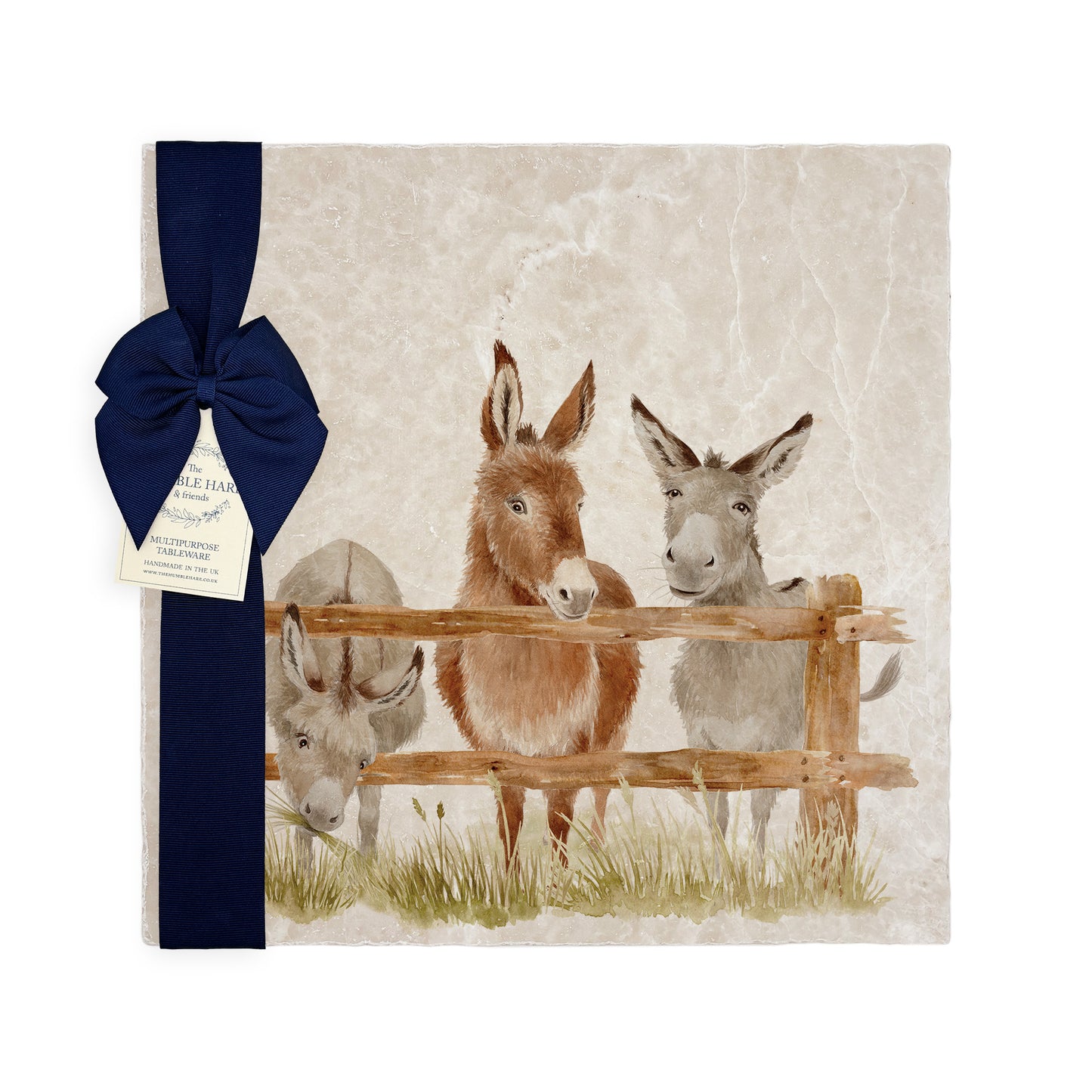 A large multipurpose marble platter with a watercolour design featuring three donkeys at a wooden fence, packaged with a luxurious dark blue bow and branded gift tag.