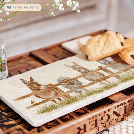 A rectangular marble sharing platter set on a coffee table to serve pastries.