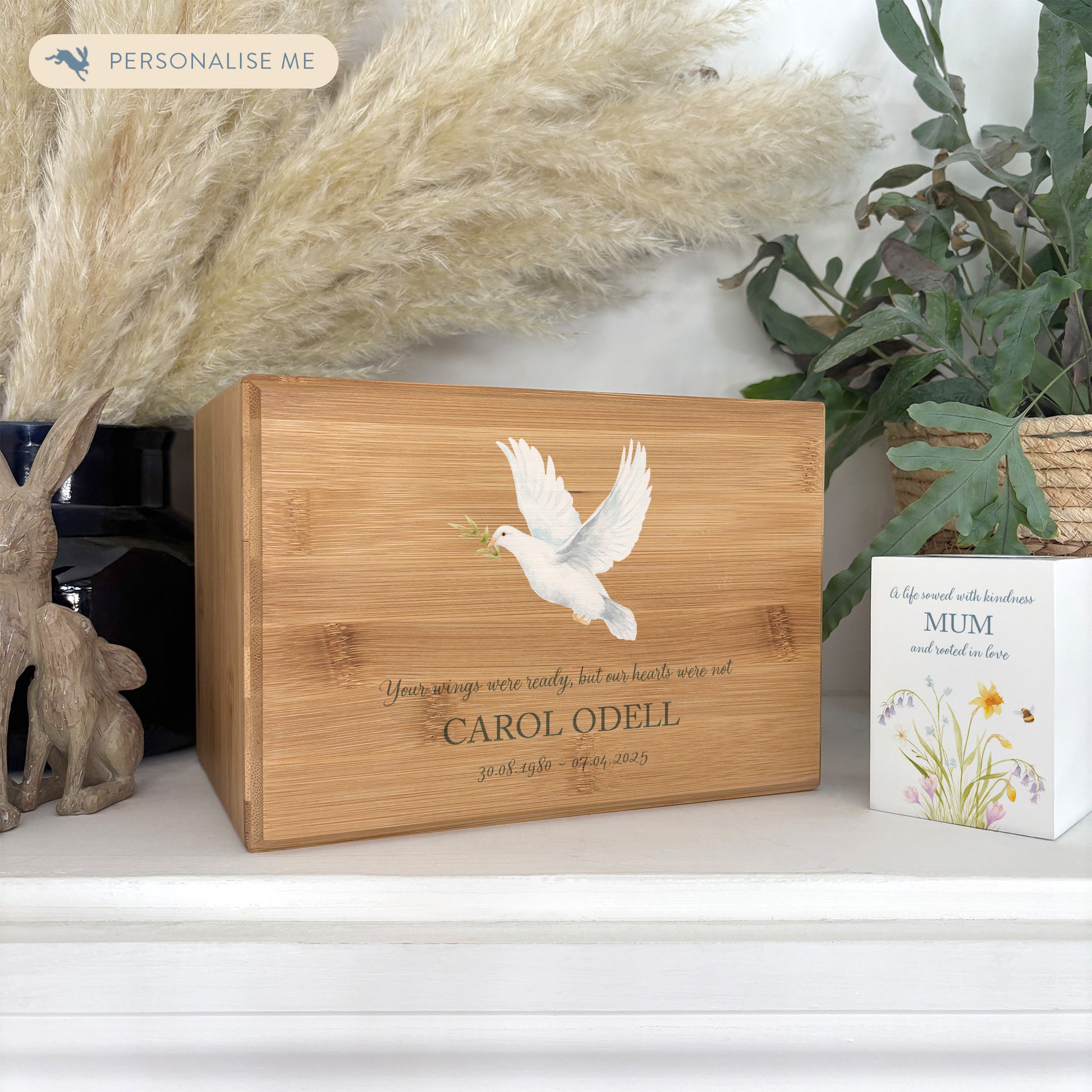 A beautifully crafted solid Bamboo wooden urn, personalised and finished with a soft watercolour design of a flying Dove, Thoughtfully made for either display or burial, this personalised urn can be customised to create a meaningful memorial. Perfect for holding ashes of a loved one or a beloved pet, it serves as a comforting tribute and keepsake.
