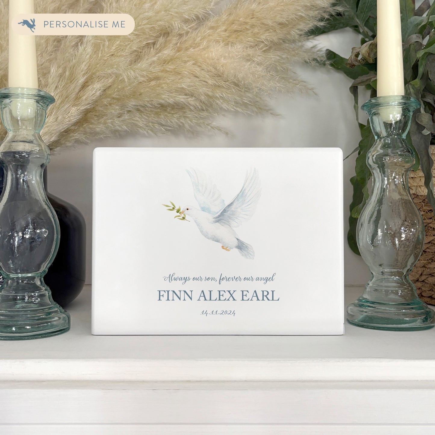 A beautifully crafted solid wooden urn, finished in white with a soft watercolour design of fa flying Dove. Thoughtfully made for either display or burial, this personalised urn can be customised to create a meaningful memorial. Perfect for holding ashes of a loved one or a beloved pet, it serves as a comforting tribute and keepsake.