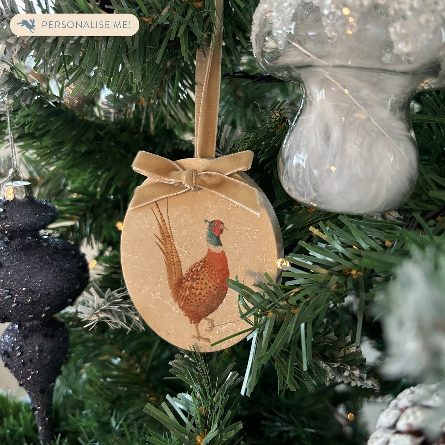 Celebrate the season in style with our oval-shaped marble baubles, featuring exquisite watercolour designs of countryside animals. Each bauble is finished with a velvet ribbon in your preferred colour and can be personalised to make your holiday décor truly unique.