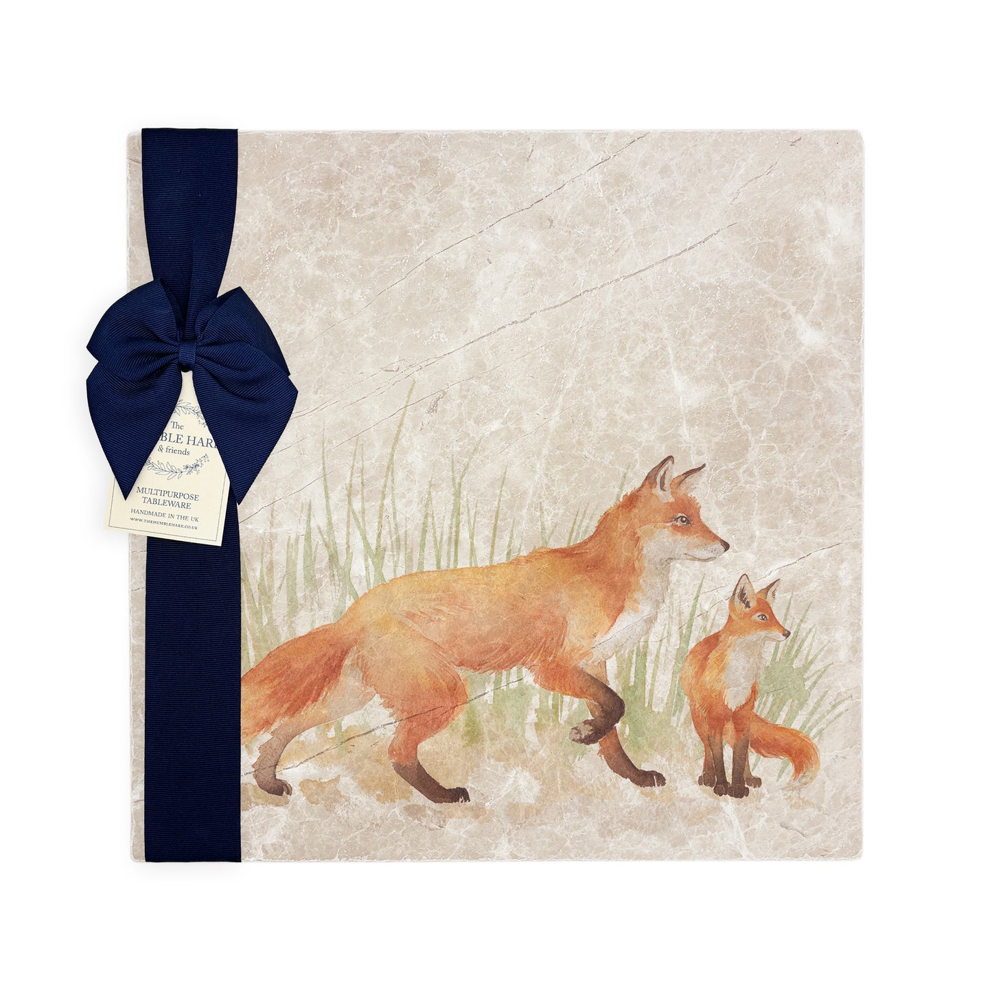 A multipurpose marble platter with a fox and fox cub design, packaged with a luxurious dark blue bow and branded gift tag.