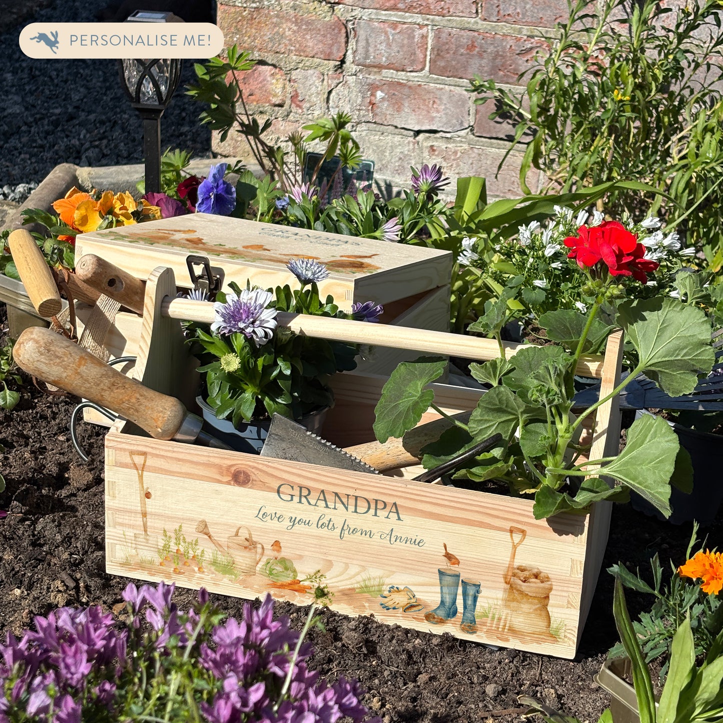wooden luxury Trug/Caddy the perfect personalised gift. Each product is lovingly designed, handmade with our Countryside inspired watercolour designs. This design features a gardening scene with wellie boots, a sake of potatoes, vegetables, a watering con and a little robin. set in a flower bed unique designs for a truly one off special occasion for a loved one.