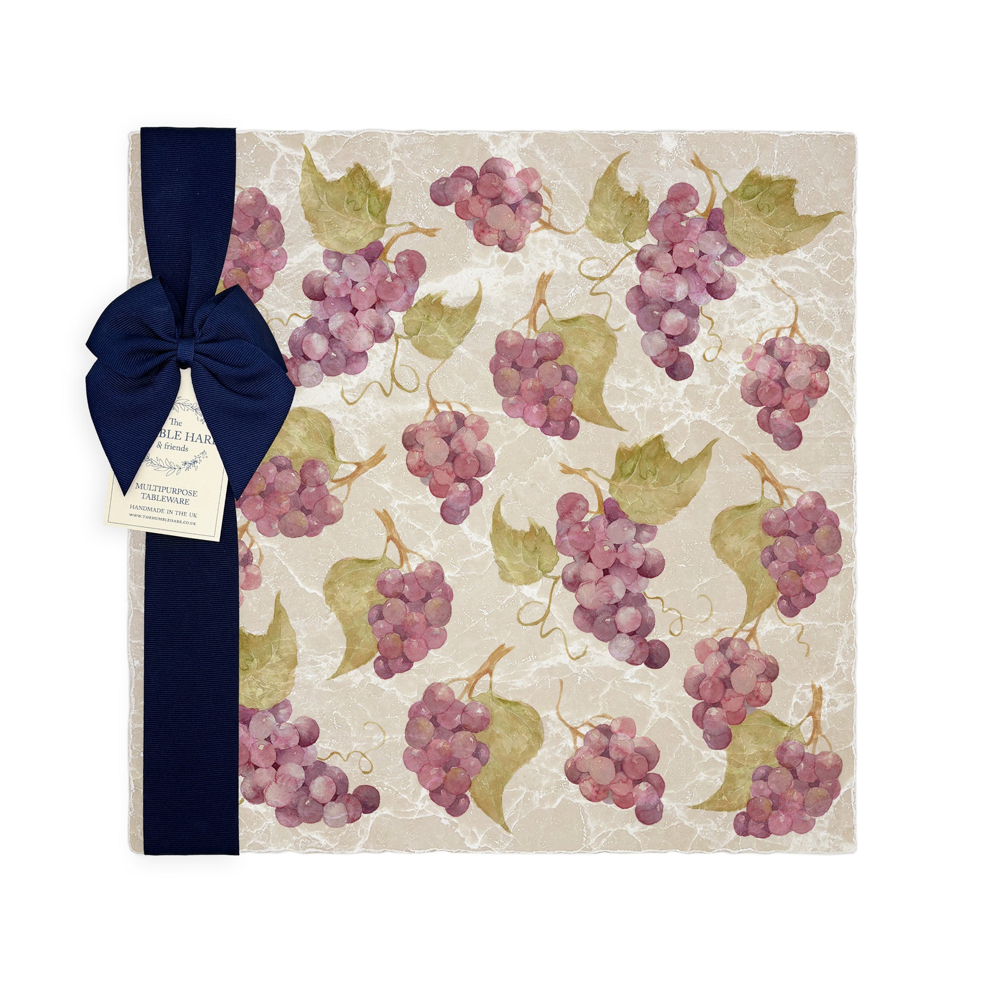 A large multipurpose marble platter with a watercolour grape vine pattern, packaged with a luxurious dark blue bow and branded gift tag.
