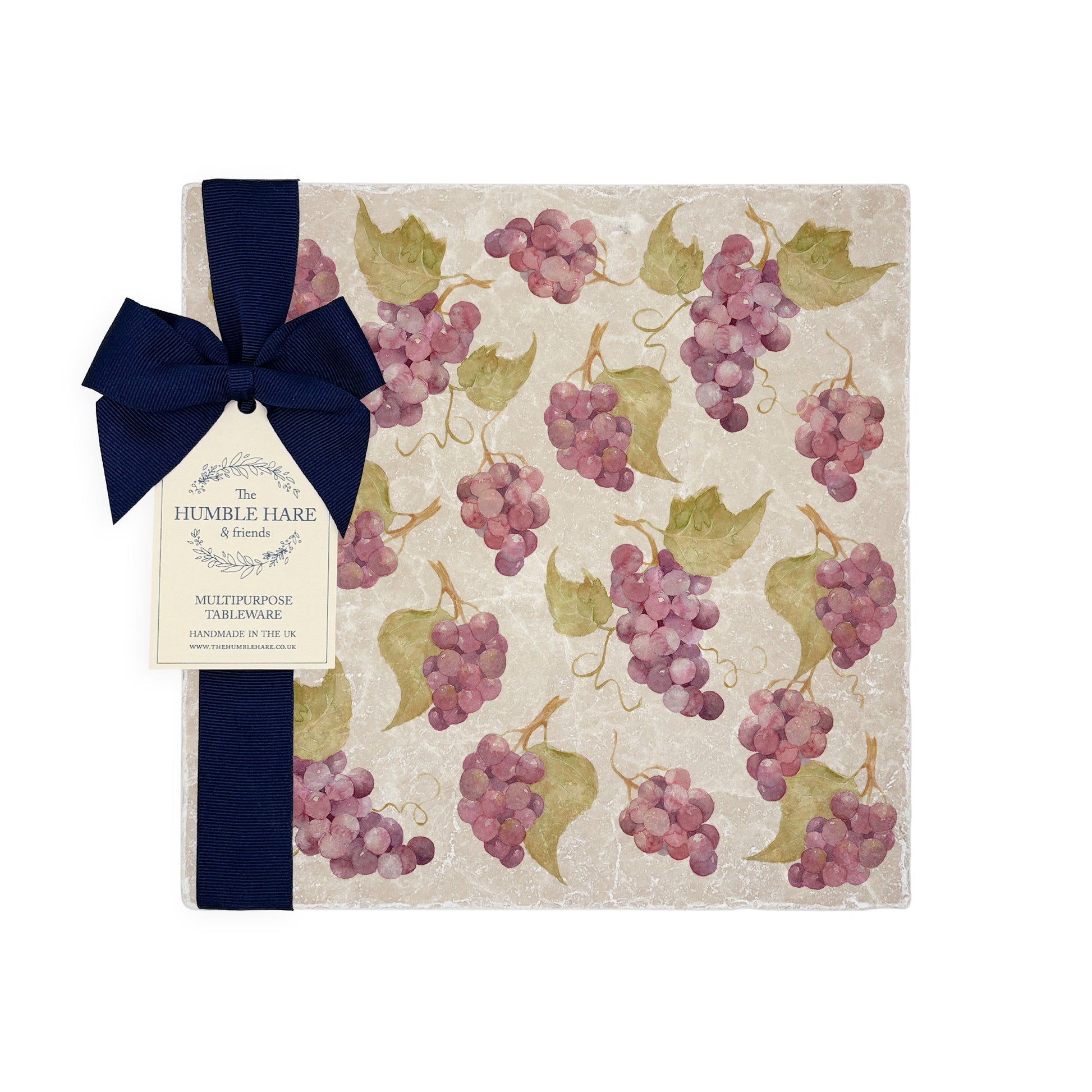 A medium multipurpose marble platter with a watercolour grape vine pattern, packaged with a luxurious dark blue bow and branded gift tag.