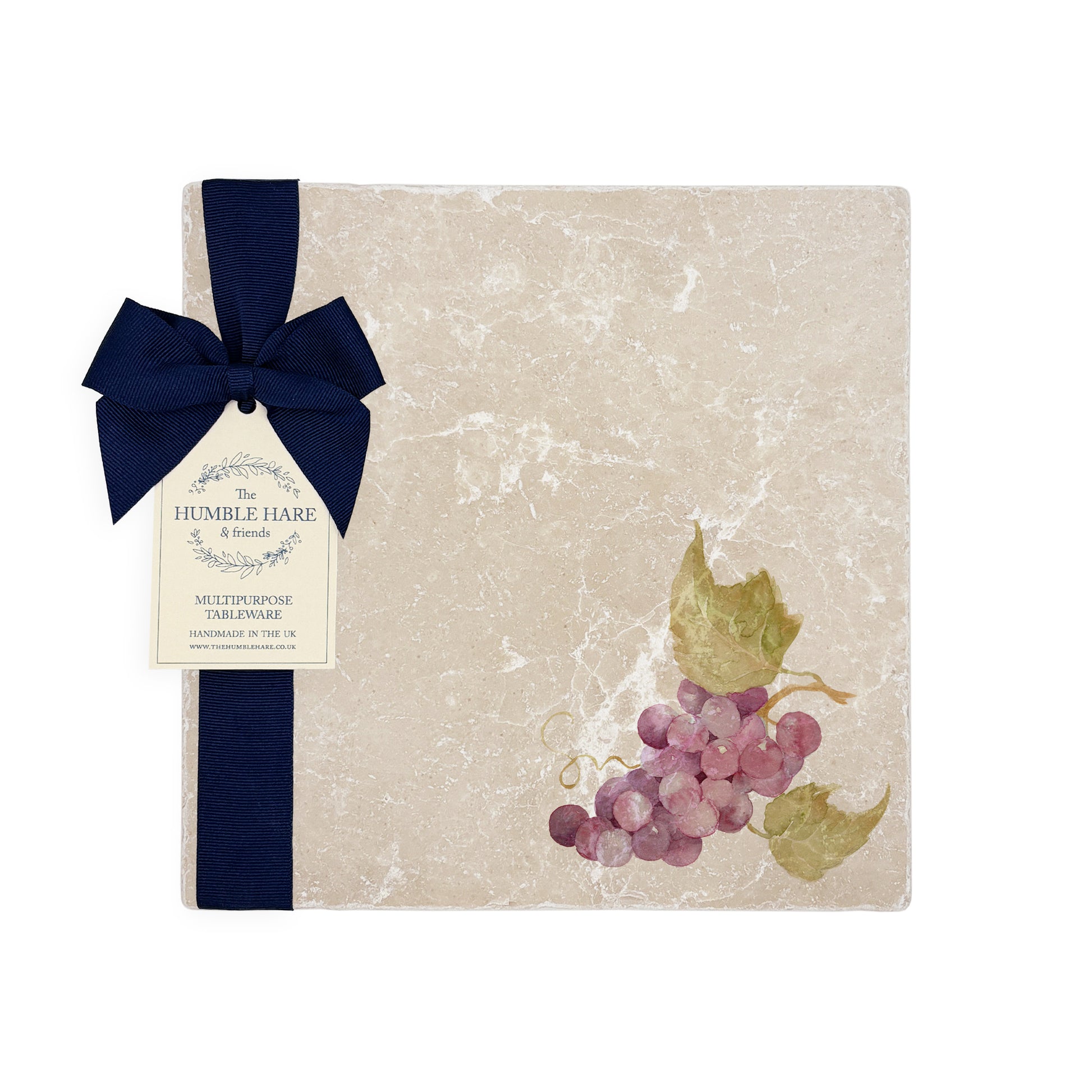 A medium multipurpose marble platter with a watercolour grape vine design, packaged with a luxurious dark blue bow and branded gift tag.