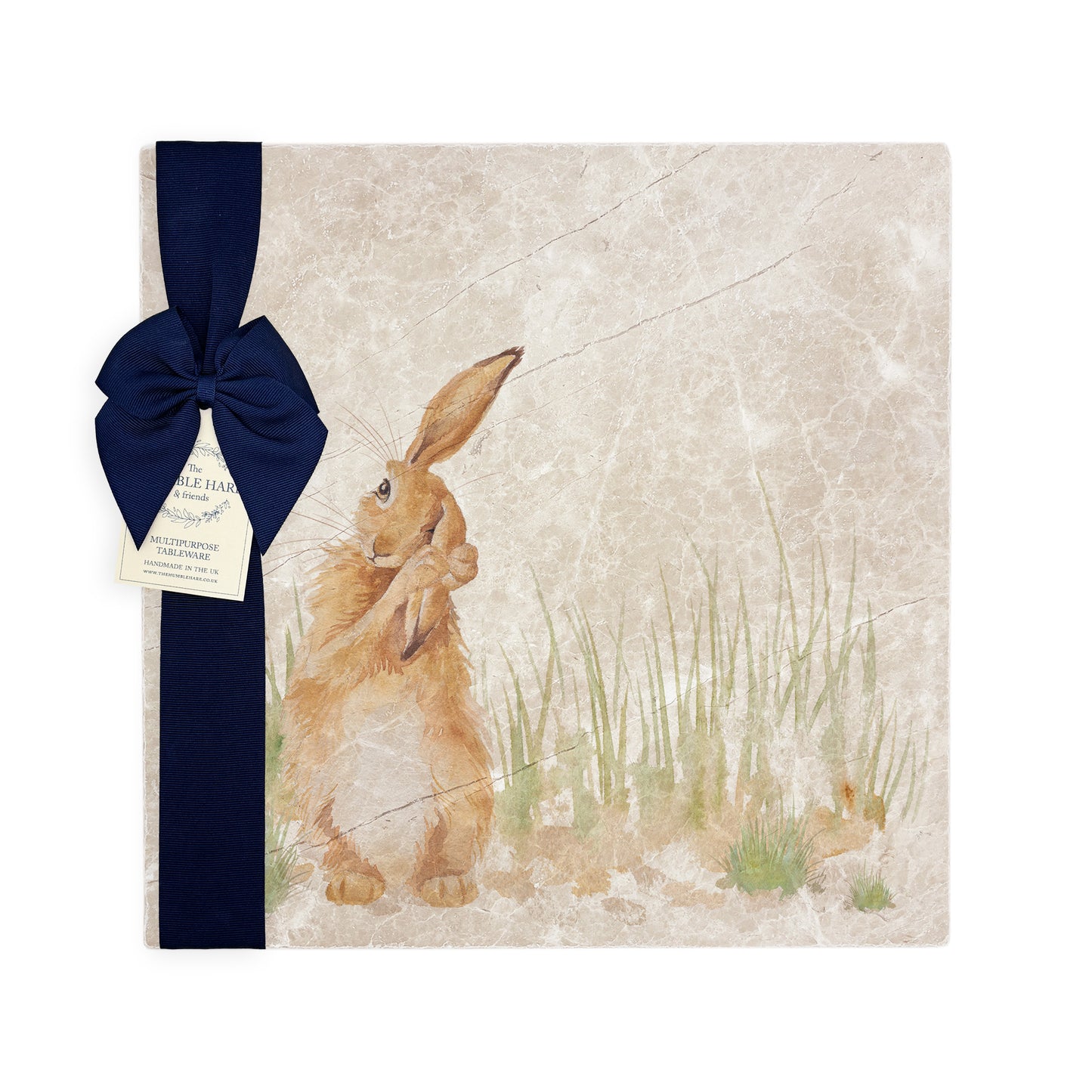 A multipurpose marble platter with a design featuring a hare washing his ear, packaged with a luxurious dark blue bow and branded gift tag.