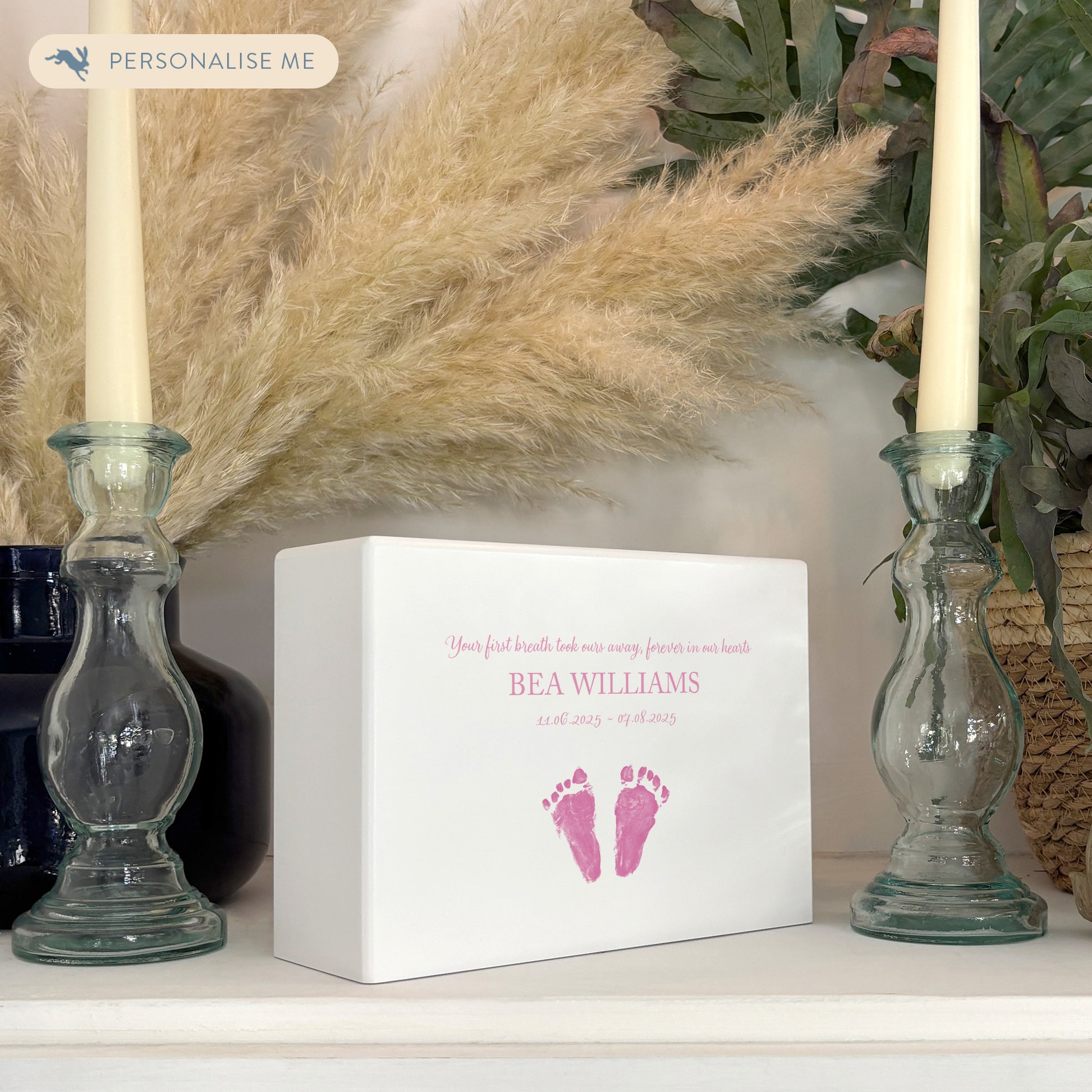 A beautifully crafted solid wooden urn, finished in white with a soft watercolour design of baby's handprints and footprints, Thoughtfully made for either display or burial, this personalised urn can be customised to create a meaningful memorial. Perfect for holding ashes of a loved one or a beloved pet, it serves as a comforting tribute and keepsake. Helping with baby loss