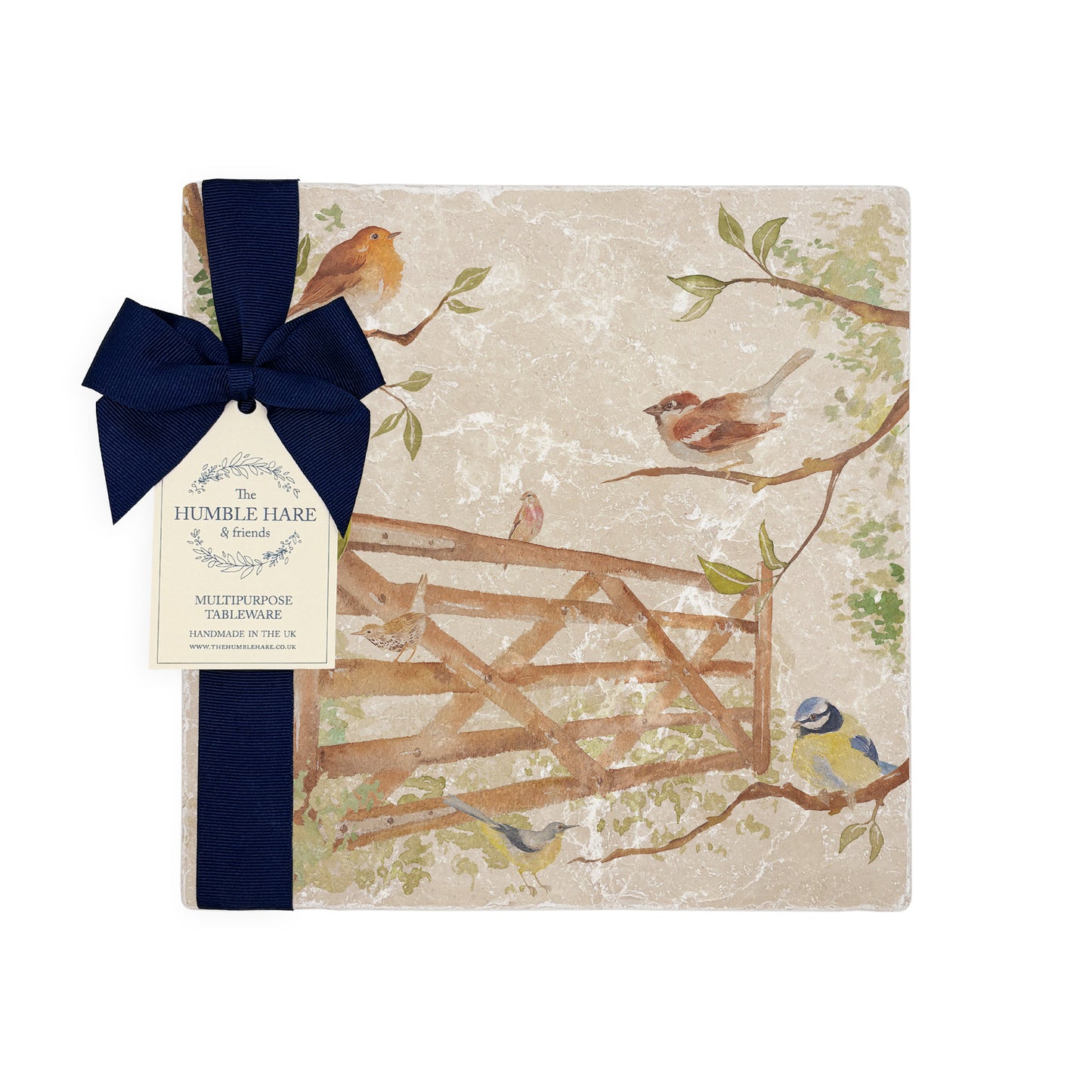 A multipurpose medium marble platter with a design featuring British garden birds in the hedgerow around the paddock gate, packaged with a luxurious dark blue bow and branded gift tag.