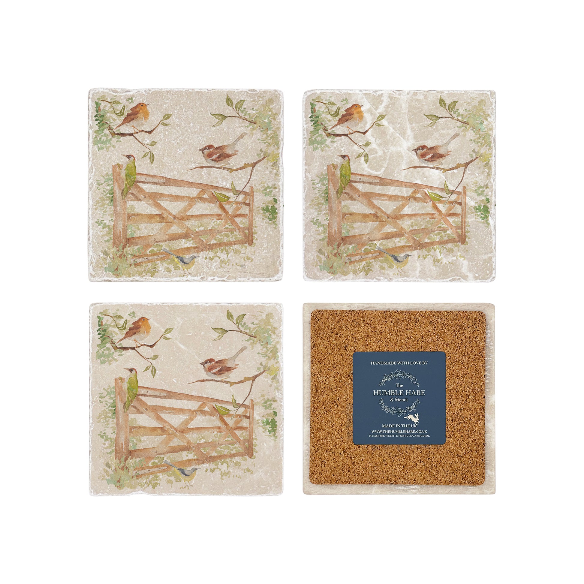 A set of four square marble coasters, featuring a watercolour design of British garden birds in the hedgerow around the paddock gate. One coaster is flipped to show that the coasters are backed with cork.