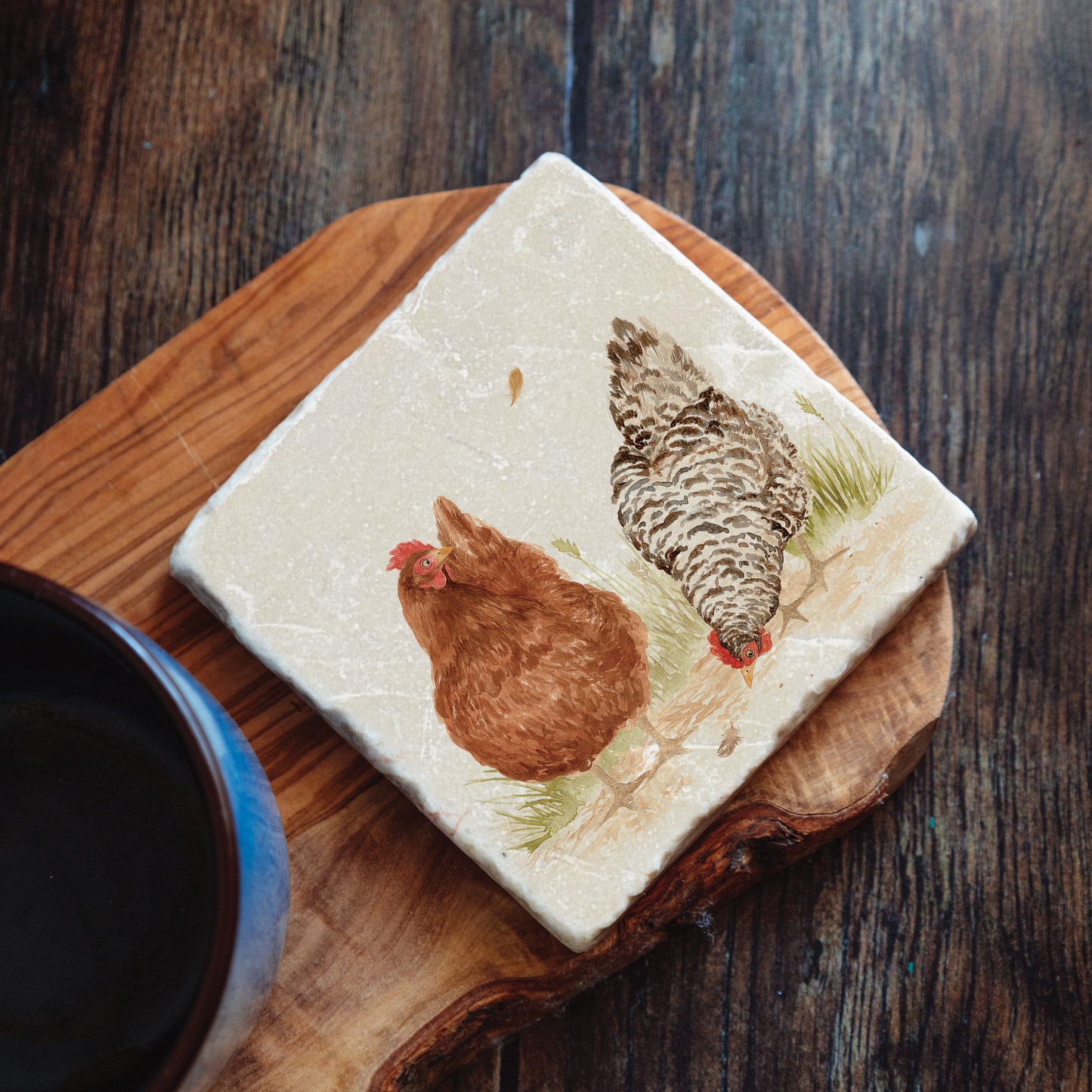 A handmade marble coaster featuring a watercolour design of two hens scratching for seeds.