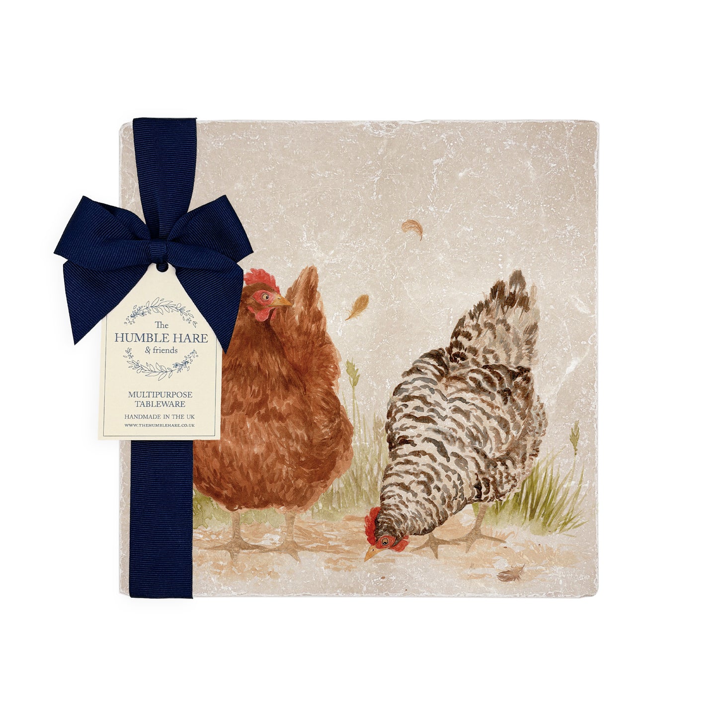 A medium multipurpose marble platter with a watercolour design of two hens, packaged with a luxurious dark blue bow and branded gift tag.