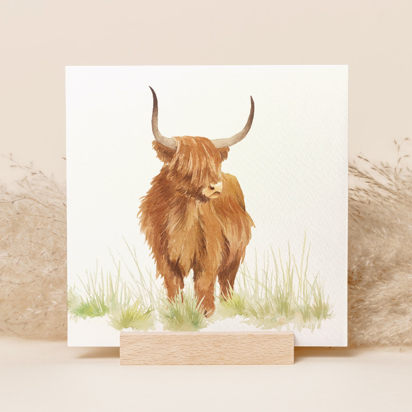 A greetings card featuring a highland cow in a watercolour style.