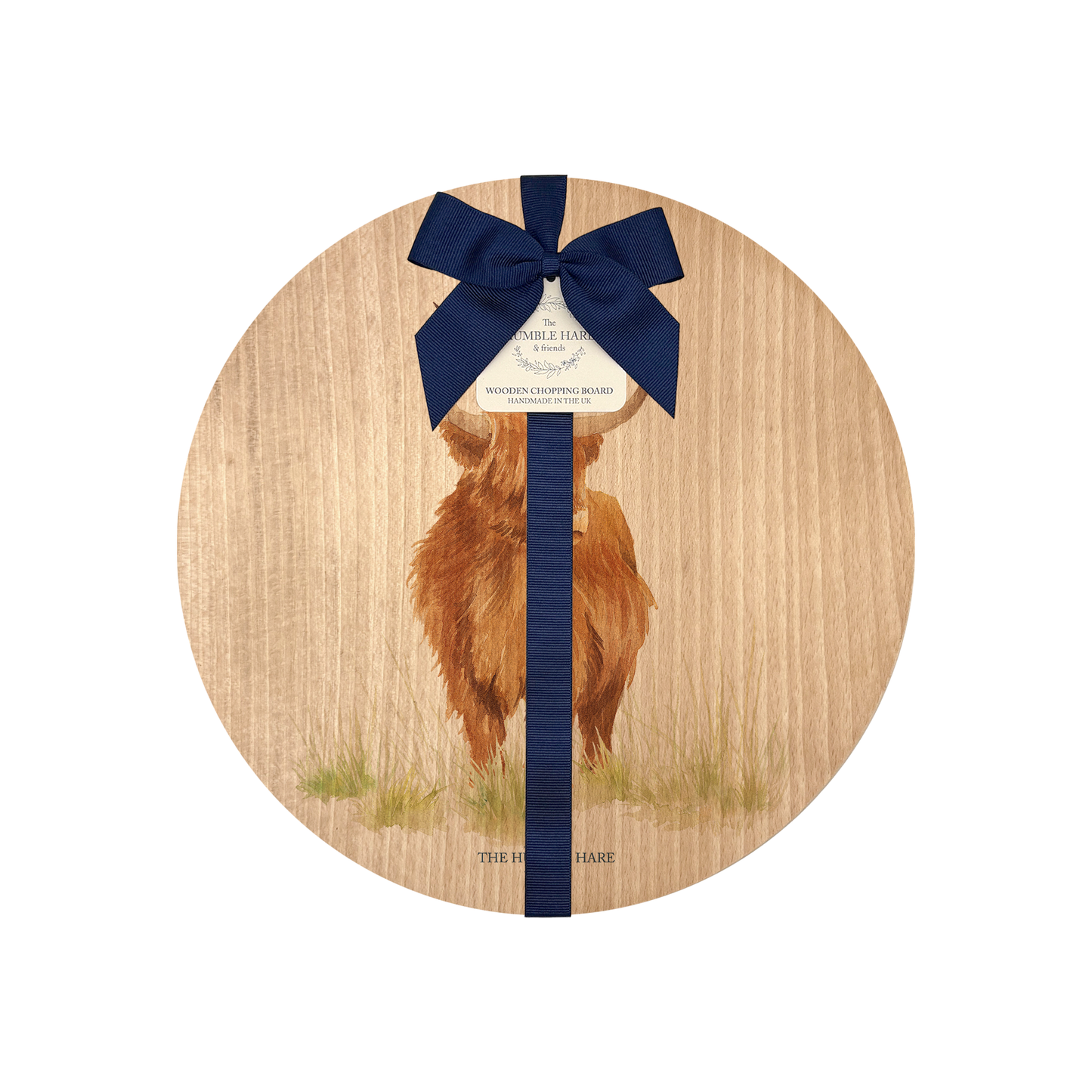 Handmade wooden chopping board featuring a watercolour Highland cow illustration, tied with blue ribbon.