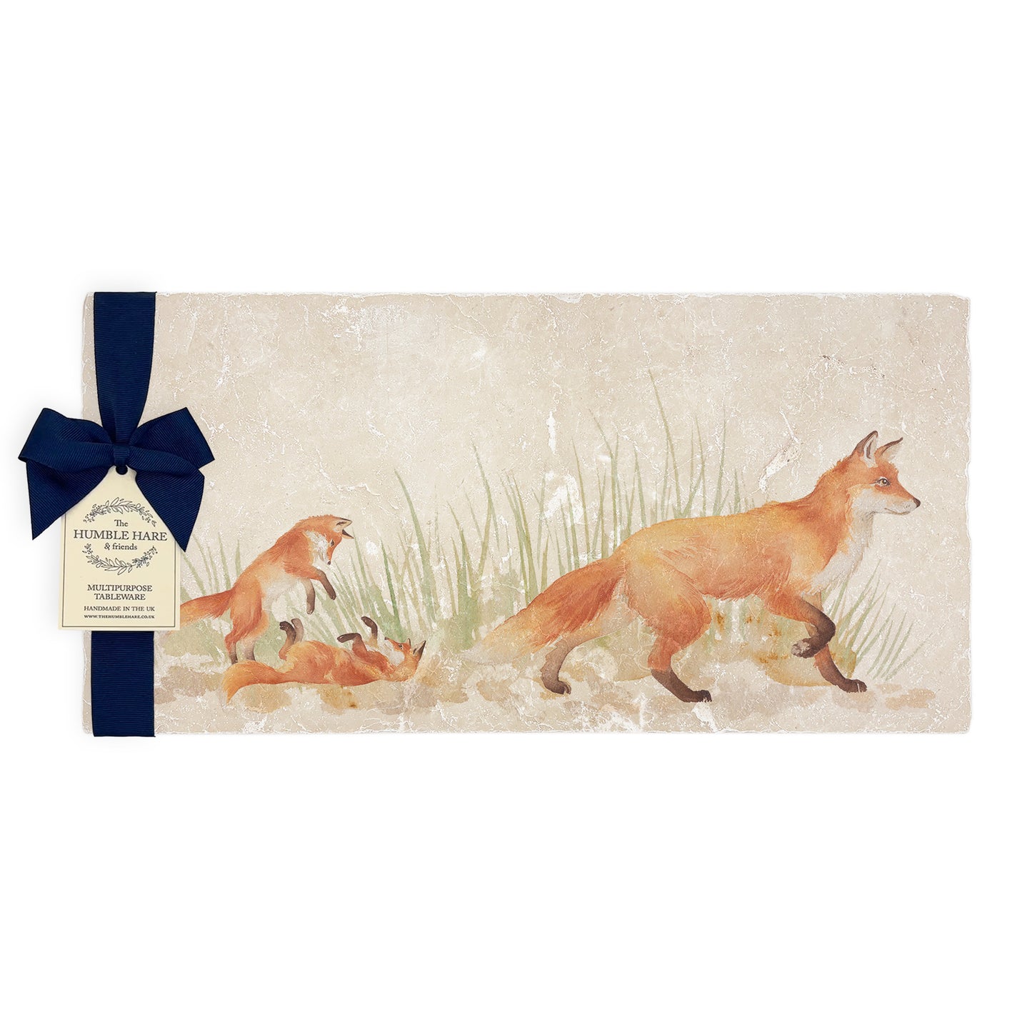 A multipurpose marble sharing platter with a fox and fox cub design, packaged with a luxurious dark blue bow and branded gift tag.