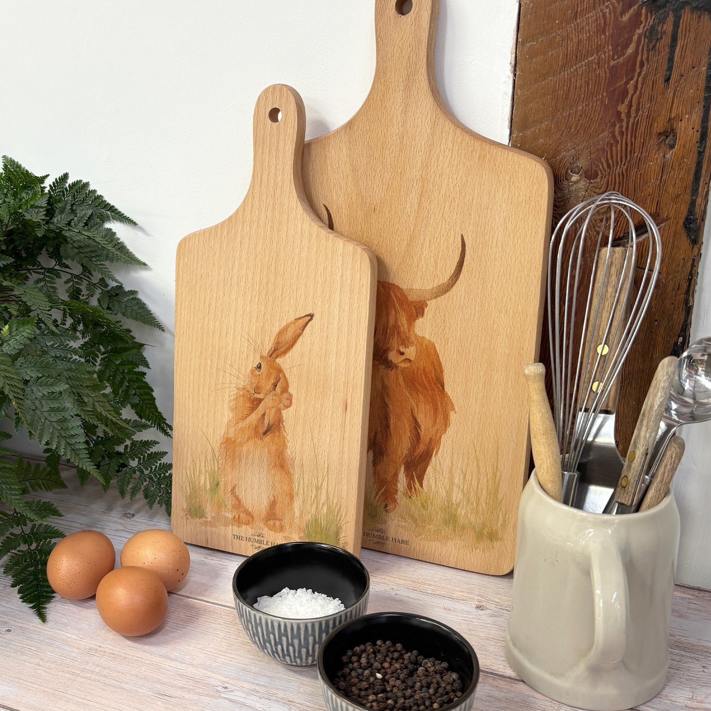 Handmade paddle board in Beech wood, featuring a water colour Hare design with a hand tied luxury blue ribbon. perfect chopping board, charcuterie board, serving board and chopping board.