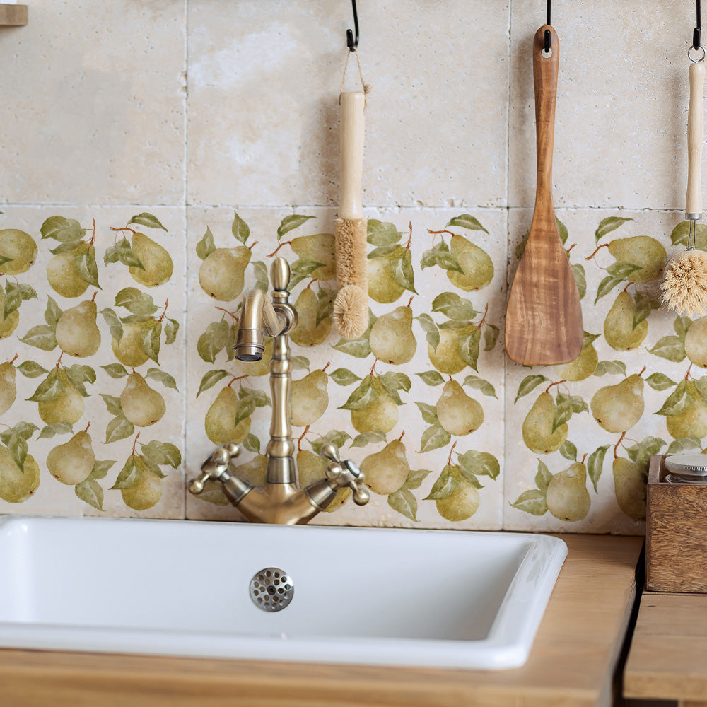 A farmhouse kitchen sink with a marble splash back made up of large 30.5x30.5cm cream marble tiles, featuring a maximalist watercolour pear pattern.