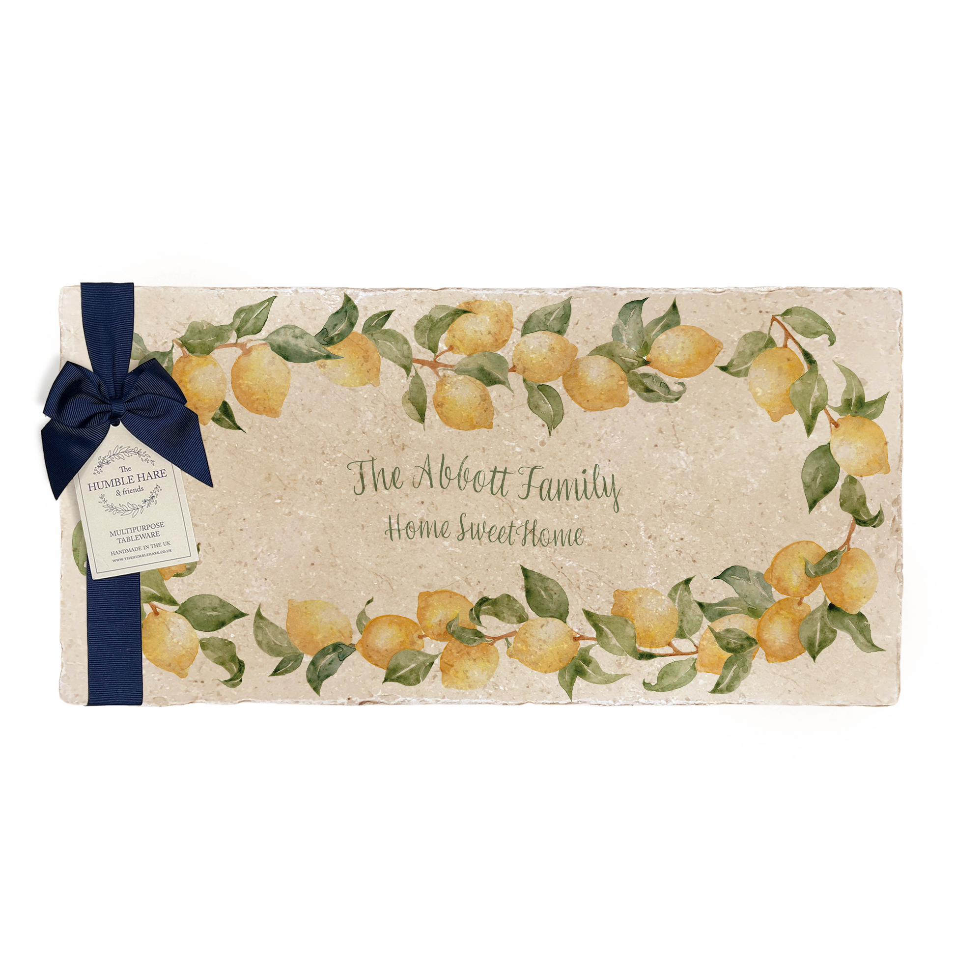 A personalised marble sharing platter featuring a wreath of lemons and leaves, with a bespoke message in the centre of the design. The platter is packaged with a luxurious blue gift bow and tag.