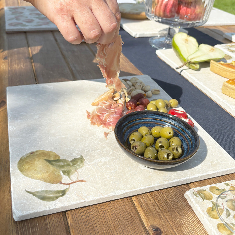A large square charcuterie board with a simple watercolour pear design.