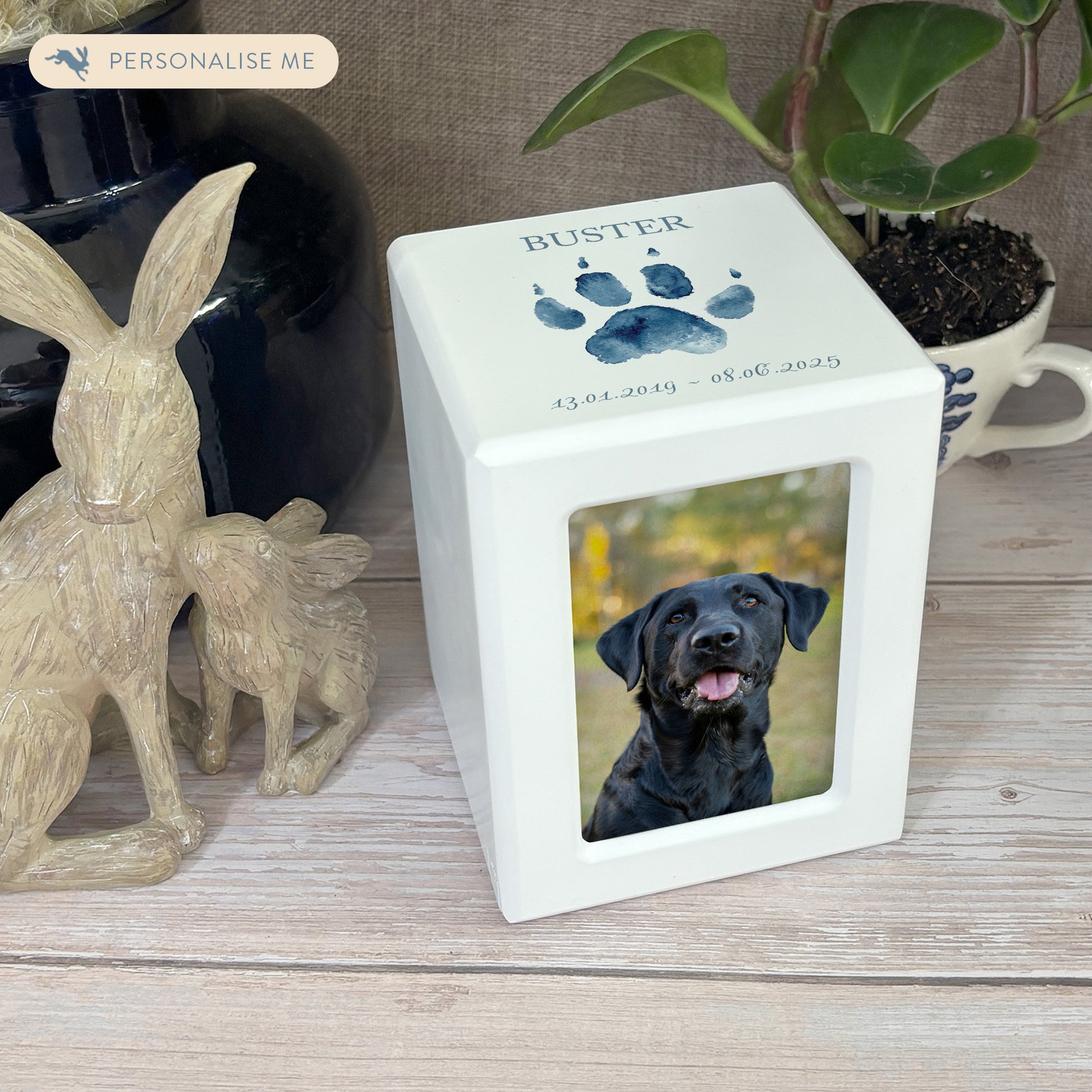 A beautifully crafted solid wooden pet photo urn for ashes, finished in white with a soft watercolour design of your cat or dogs paw print, Thoughtfully made for either display or burial, this personalised urn can be customised to create a meaningful memorial. Perfect for holding ashes of a beloved pet, it serves as a comforting tribute and keepsake.