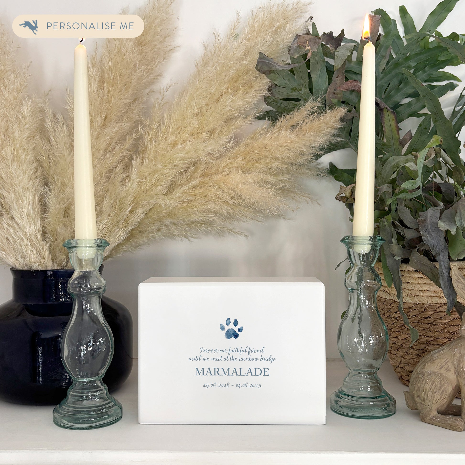 A beautifully crafted solid wooden urn, finished in white with a soft watercolour design of your cat or dogs paw print, Thoughtfully made for either display or burial, this personalised urn can be customised to create a meaningful memorial. Perfect for holding ashes of a beloved pet, it serves as a comforting tribute and keepsake.