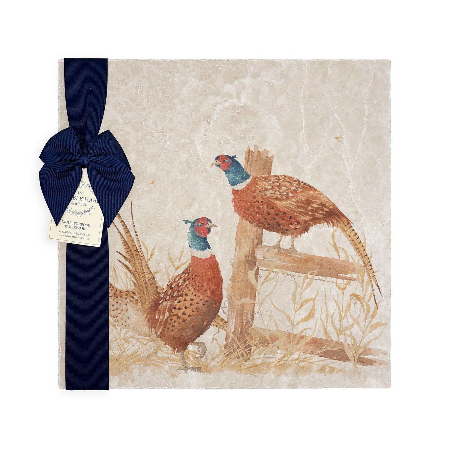 A multipurpose marble platter with a watercolour pheasant design, packaged with a luxurious dark blue bow and branded gift tag.