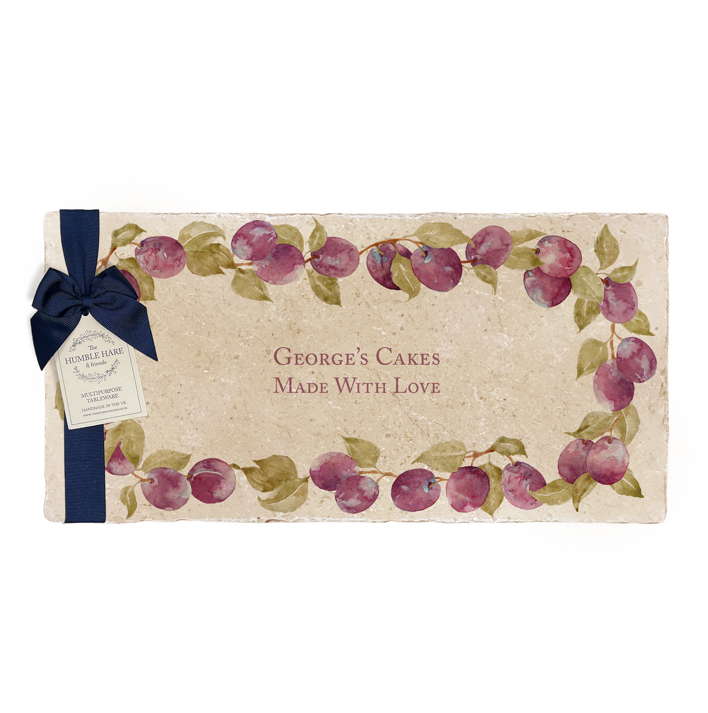 A personalised marble sharing platter featuring a wreath of plums and leaves, with a bespoke name in the centre of the design. The platter is packaged with a luxurious blue gift bow and tag.