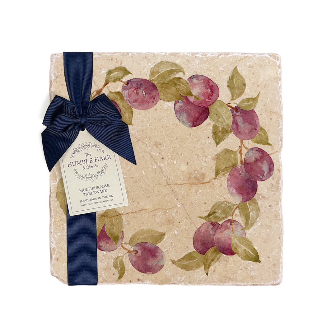 A medium multipurpose marble platter with a watercolour plum wreath design, packaged with a luxurious dark blue bow and branded gift tag.