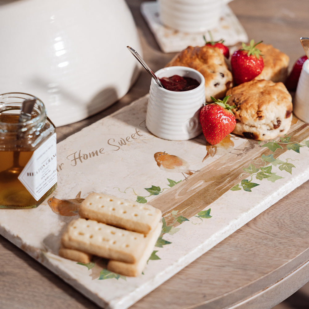 A personalised marble platter featuring a robin design set with scones, jam and fruit ready for an afternoon tea.