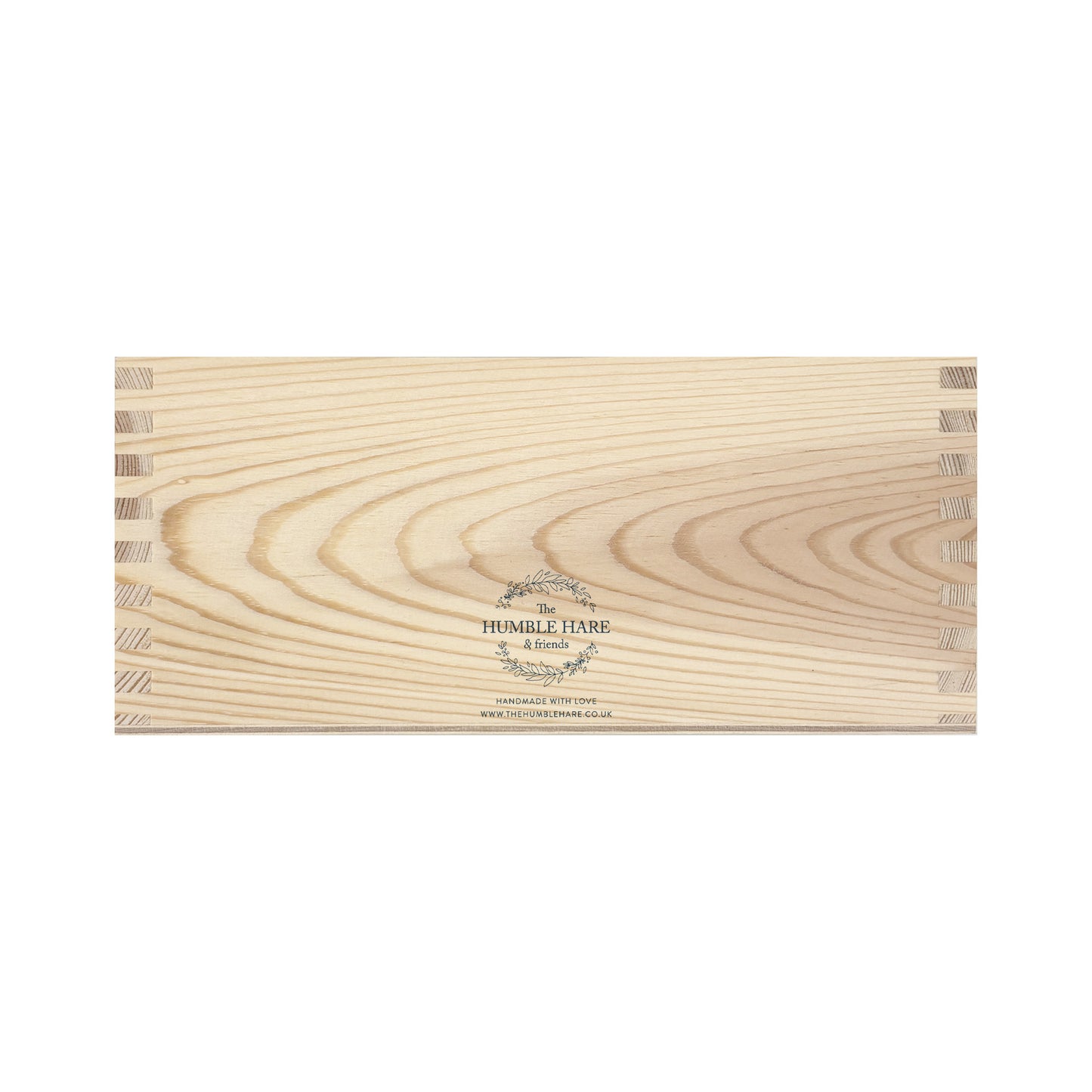 The back of a rectangle wooden planter box showing The Humble Hare logo is placed in the centre at the bottom.