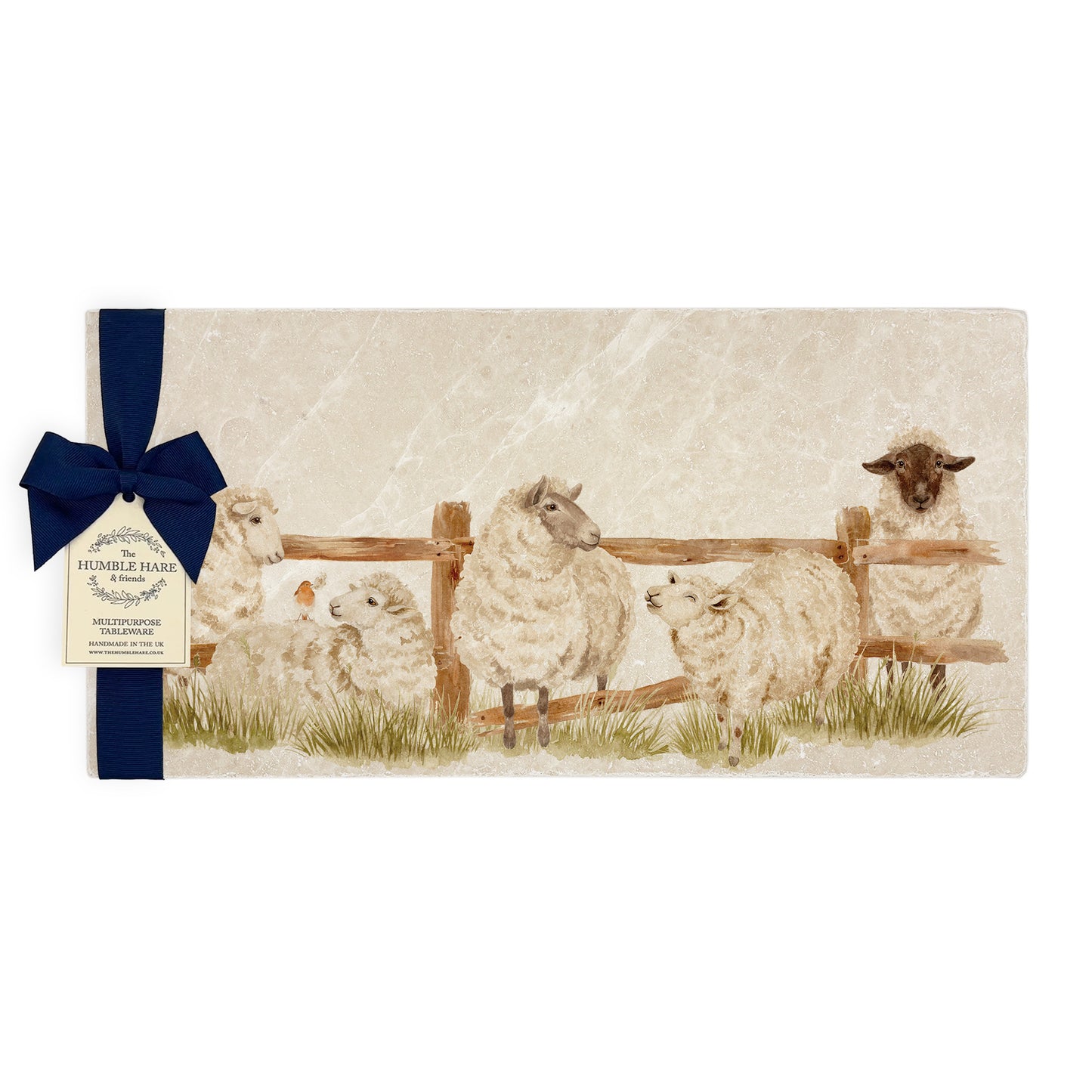 A multipurpose marble sharing platter with a watercolour design of sheep escaping from a field, packaged with a luxurious dark blue bow and branded gift tag.