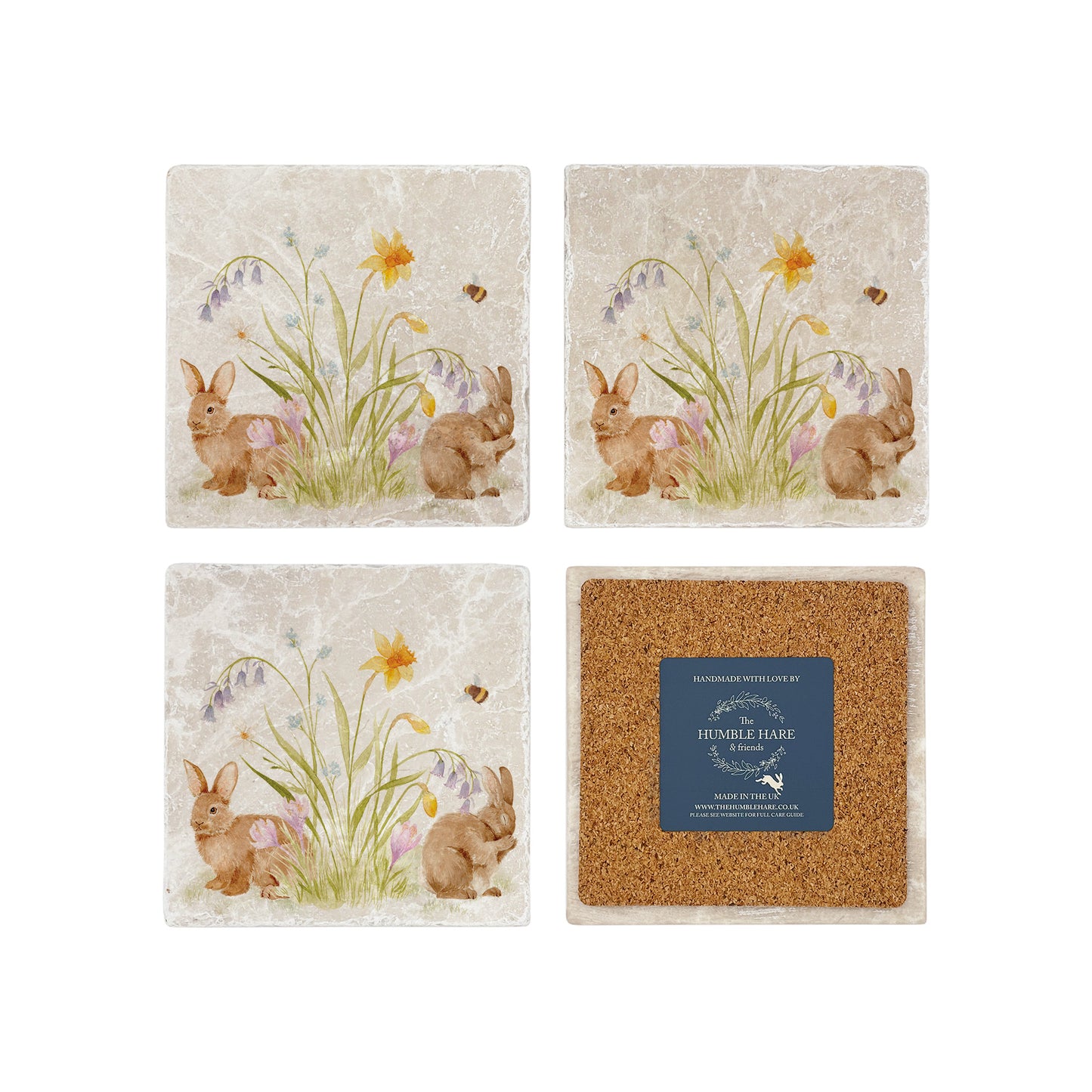 A set of four marble coasters with a watercolour design of spring flowers and cute fluffy bunnies. One coaster in the set is flipped to show that they have a cork back to protect worksurfaces.