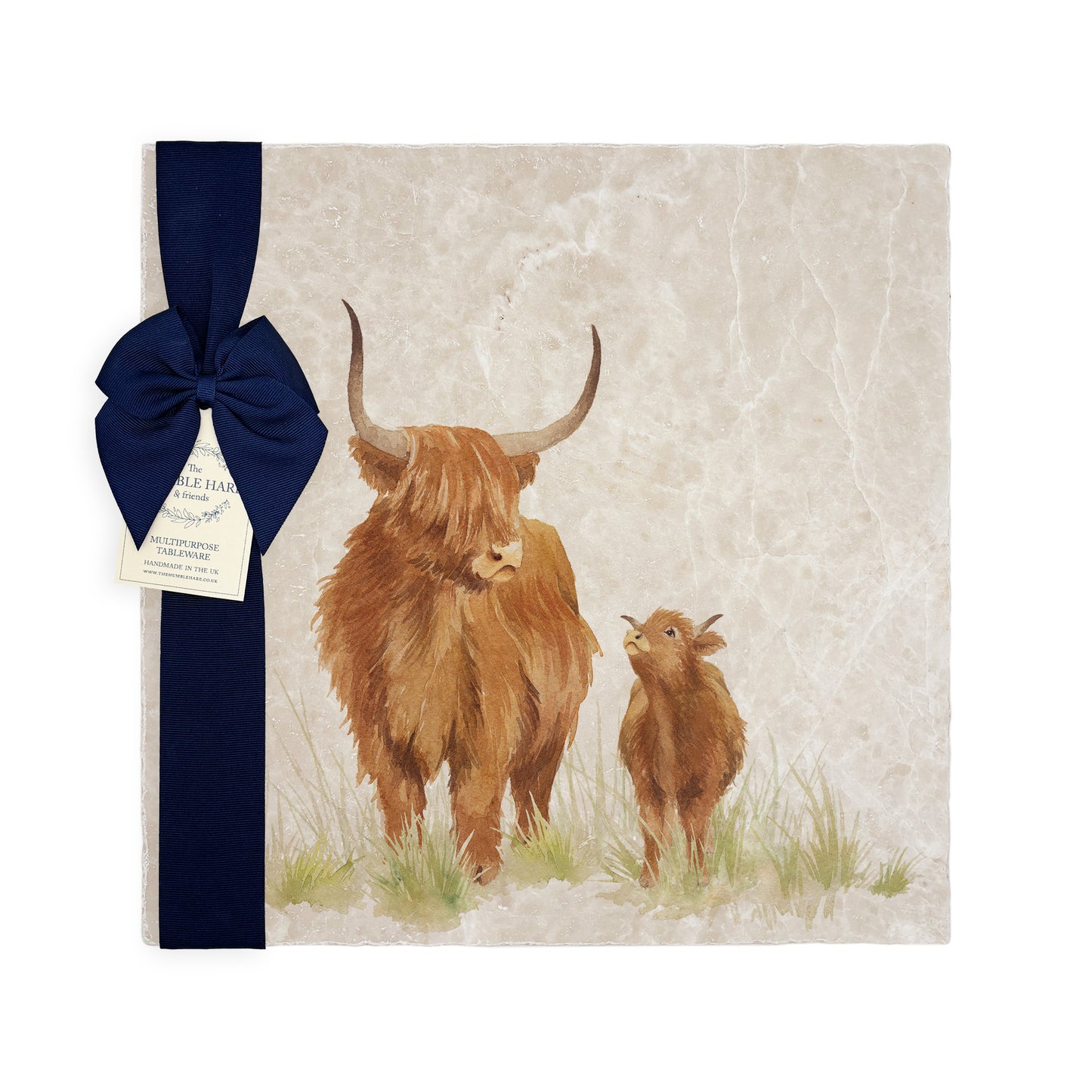 A multipurpose marble platter with a highland cow and calf design, packaged with a luxurious dark blue bow and branded gift tag.