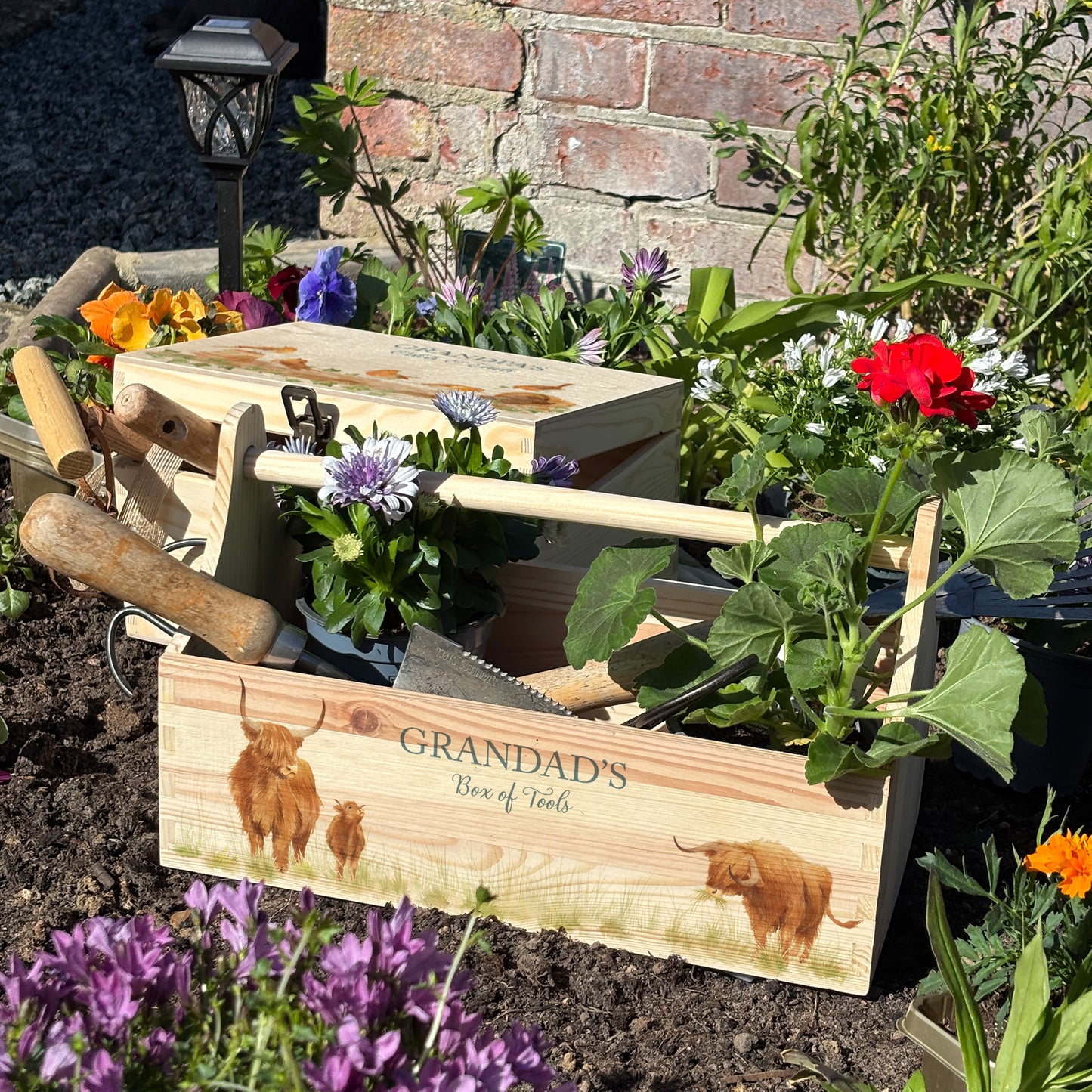 wooden luxury Trug/Caddy the perfect personalised gift. Each product is lovingly designed, handmade with our Countryside inspired watercolour designs. This design features a Highland cow set in a flower bed unique designs for a truly one off special occasion for a loved one.