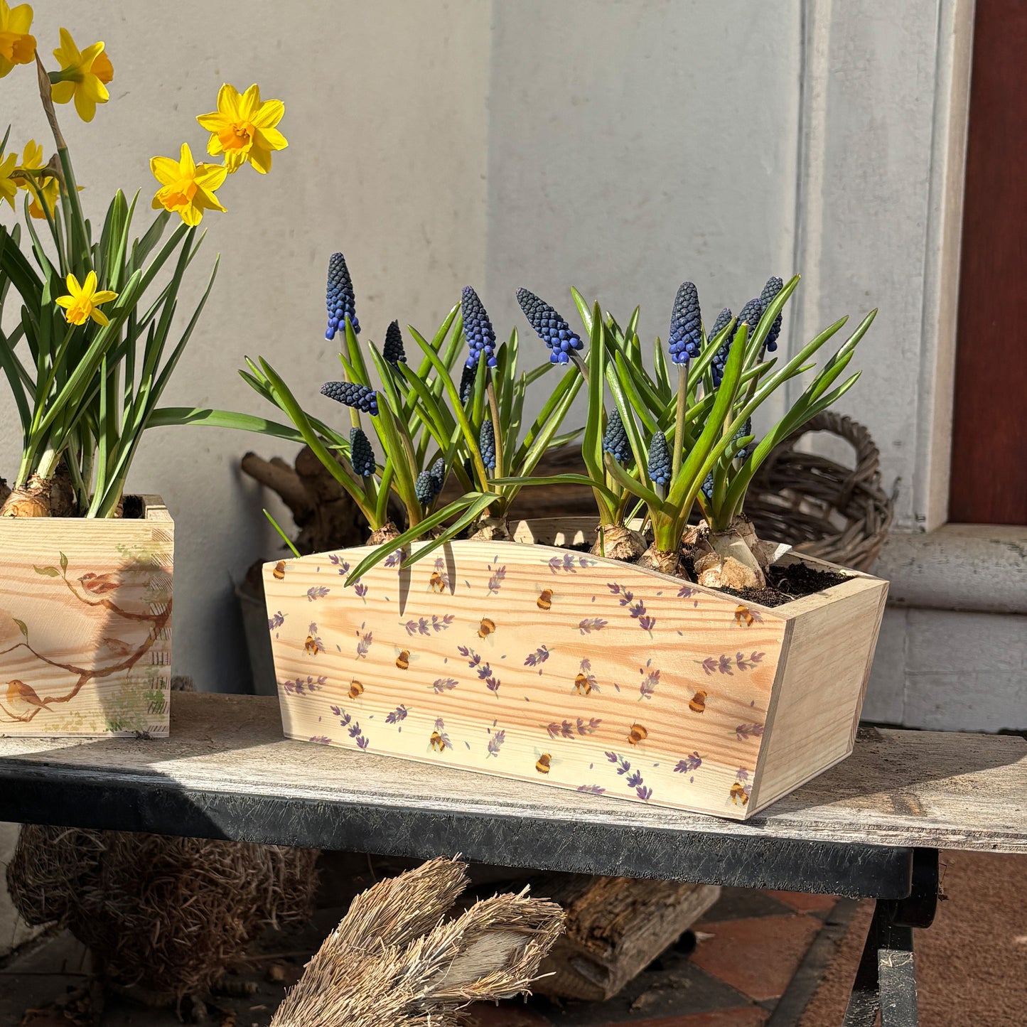 An arched wooden planter box with a watercolour design of bees and purple and lilac lavender in a pretty pattern. A perfect gift for any occasion including birthdays, anniversaries and new home presents.