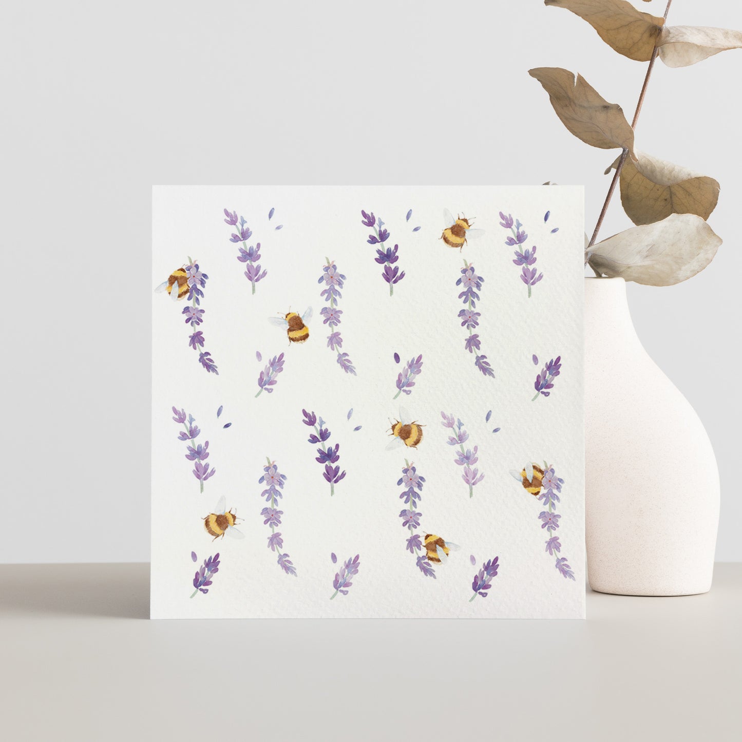 A square greetings card with a watercolour busy bee and purple lavender flowers pattern.