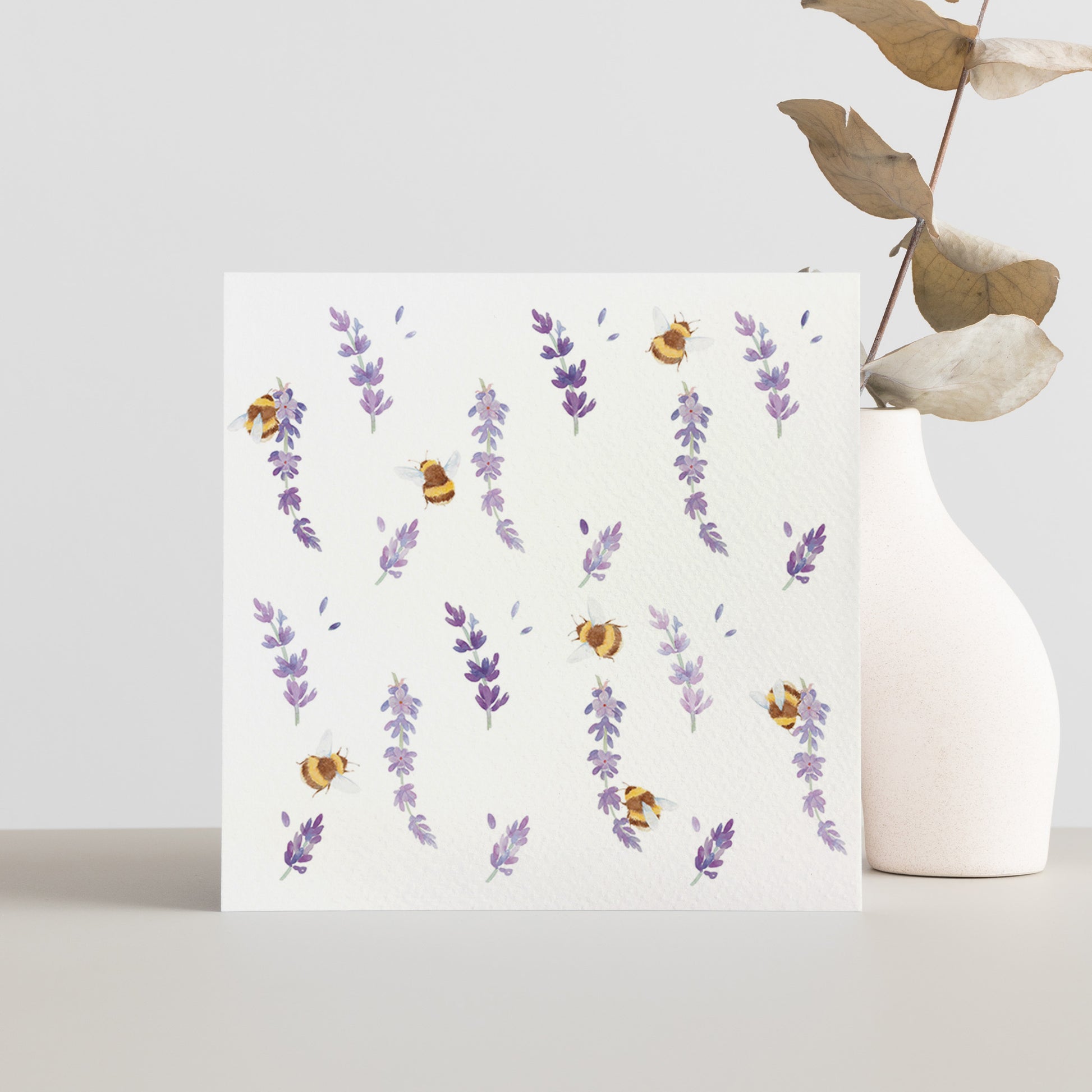 A square greetings card with a watercolour busy bee and purple lavender flowers pattern.