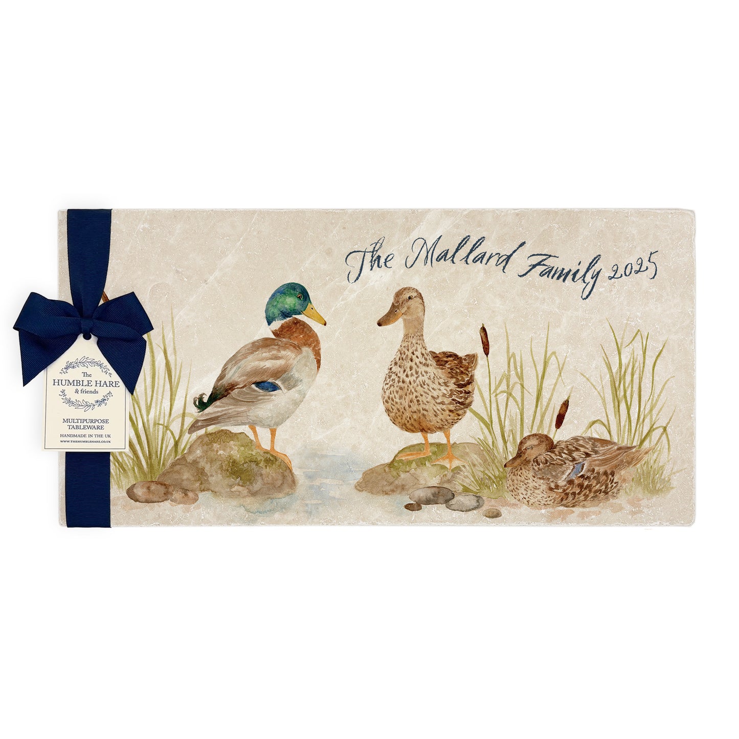 A personalised rectangular marble sharing platter featuring ducks by a pond in a watercolour style. The bespoke gift is packaged with a luxurious dark blue bow and branded gift tag.