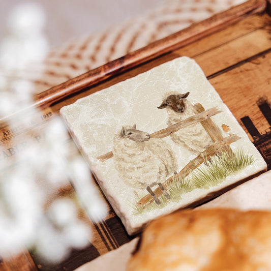 A square marble coaster featuring a watercolour design of two sheep escaping from their field through a broken fence.