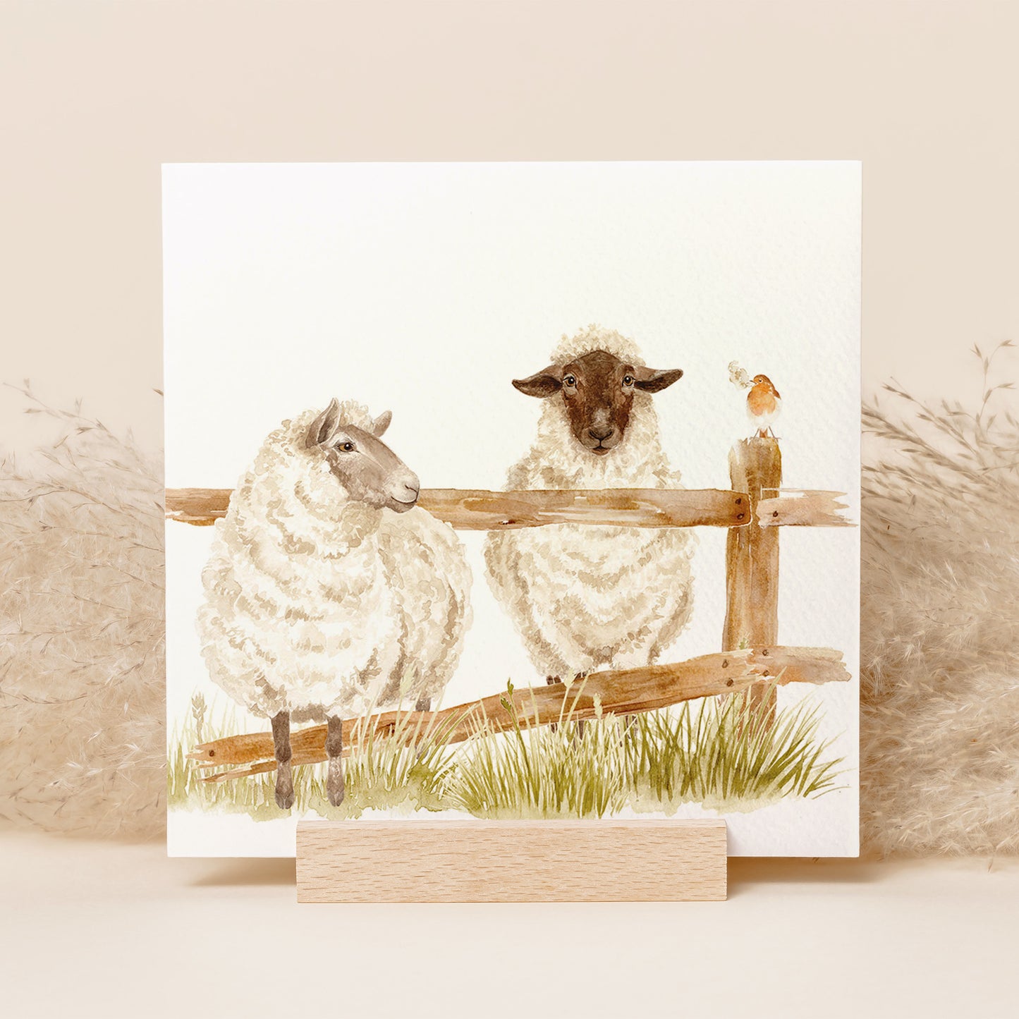 A square greetings card featuring a watercolour design of two sheep escaping through a broken fence.