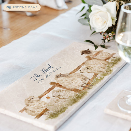 A personalised marble sharing platter set on a dining table as a centrepiece for serving dishes. The bespoke text displays the house name.