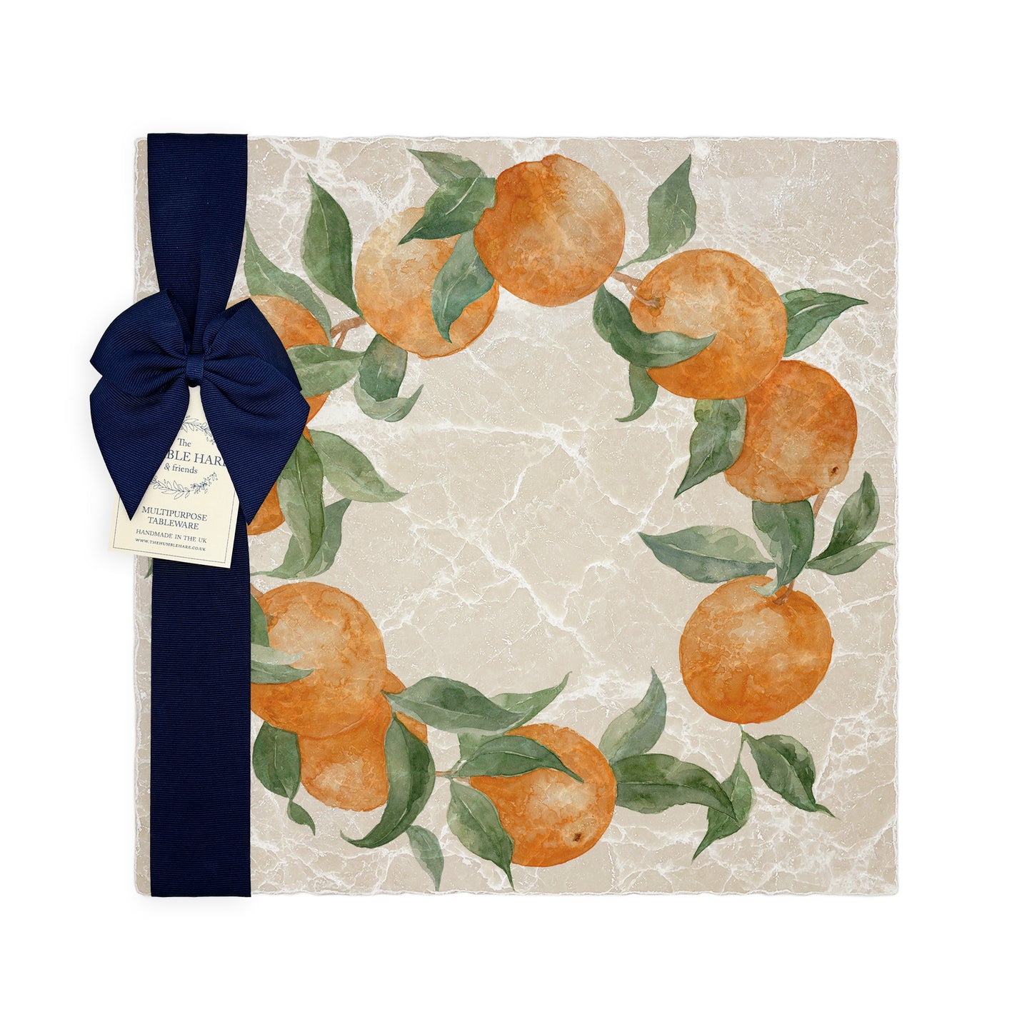 A large square marble placemat, featuring a rustic oranges and leaves wreath design.