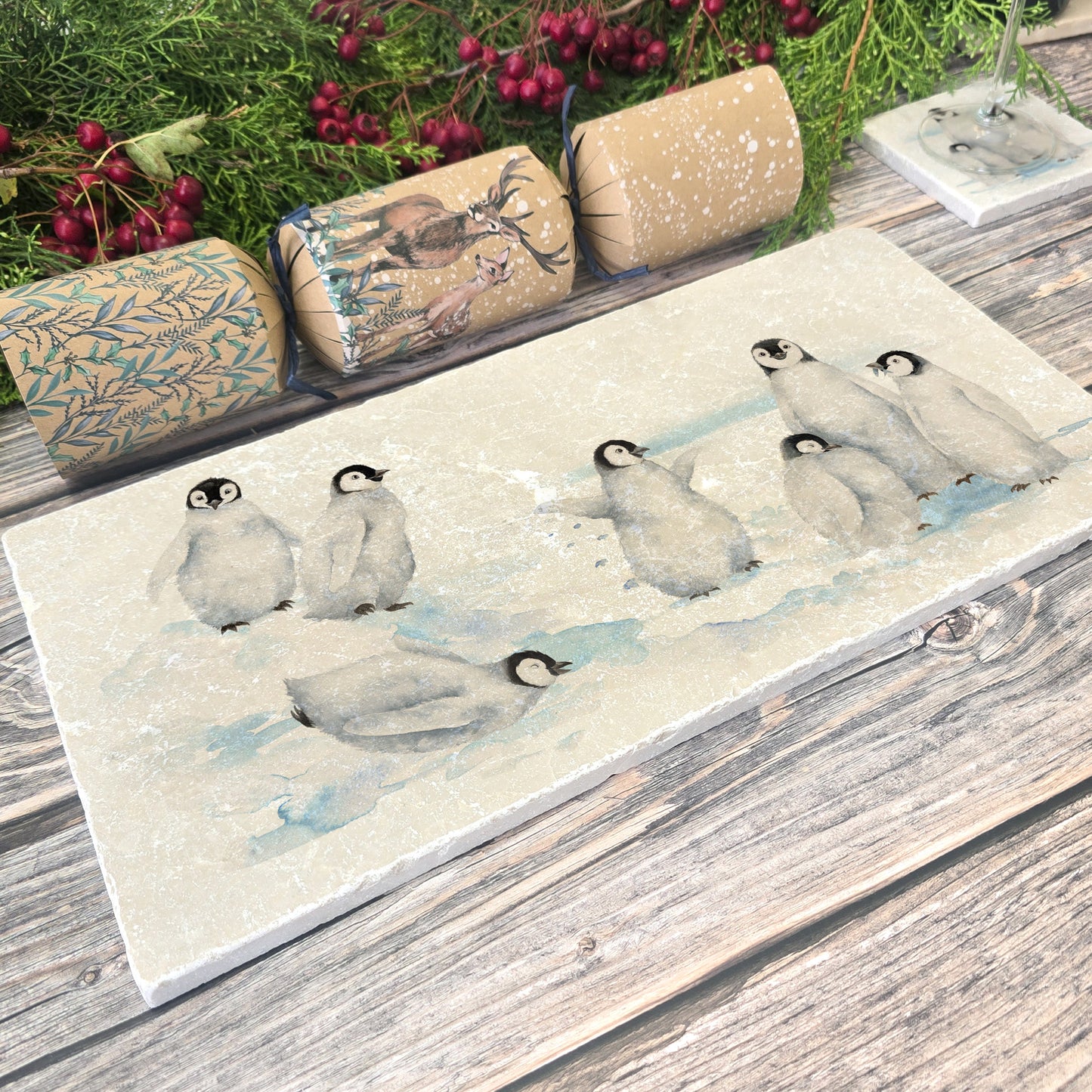 Beautiful Penguin family huddled together, with some cheeky characters having fun sliding around on their tummies, this design is on our best selling sharing platter they are in a snowy Antarctica the perfect gift finished with a blue ribbon.